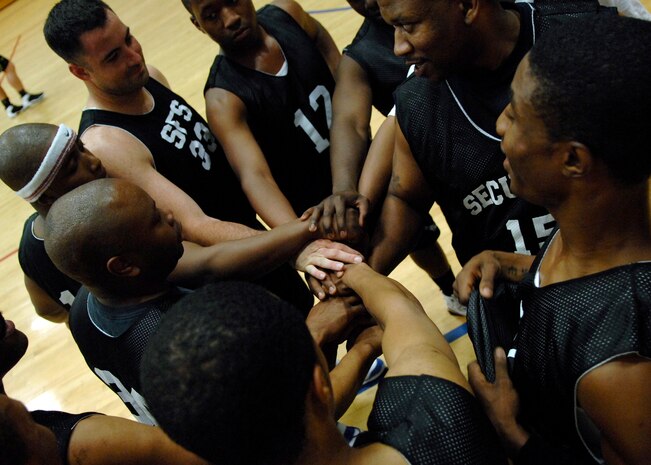 The 437th Security Forces Squadron basketball team prepares for an intramural basketball playoff game against the Coast Guard at the Fitness and Sports Center here April 20. SFS defeated the CG 51-46. The SFS team is currently the number eight seed in the playoffs. (U.S. Air Force photo/Senior Airman Katie Gieratz) (RELEASED)
