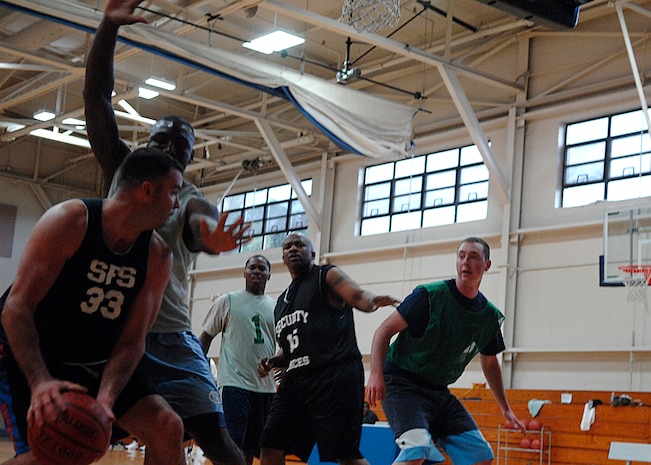 Derek Southard looks for an open player to pass the ball to during an intramural basketball playoff game at the Fitness and Sports Center here April 20. The 437th Security Forces Squadron defeated the Coast Guard 51-46. There are 14 teams in the playoffs.  Southard is a member of the 437 SFS. (U.S. Air Force photo/Senior Airman Katie Gieratz)(RELEASED)