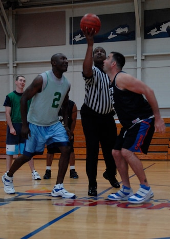 Lorenzo Woods, left, and Derek Southard, right, wait for the tip off of an intramural basketball playoff game at the Fitness and Sports Center here April 20. The 437th Security Forces Squadron defeated the Coast Guard 51-46. SFS is currently the number eight seed in the playoffs. Woods, a CG member, is with the Maritime Law Enforcement Academy and Southard is with the 437 SFS. (U.S. Air Force photo/Senior Airman Katie Gieratz)(RELEASED)