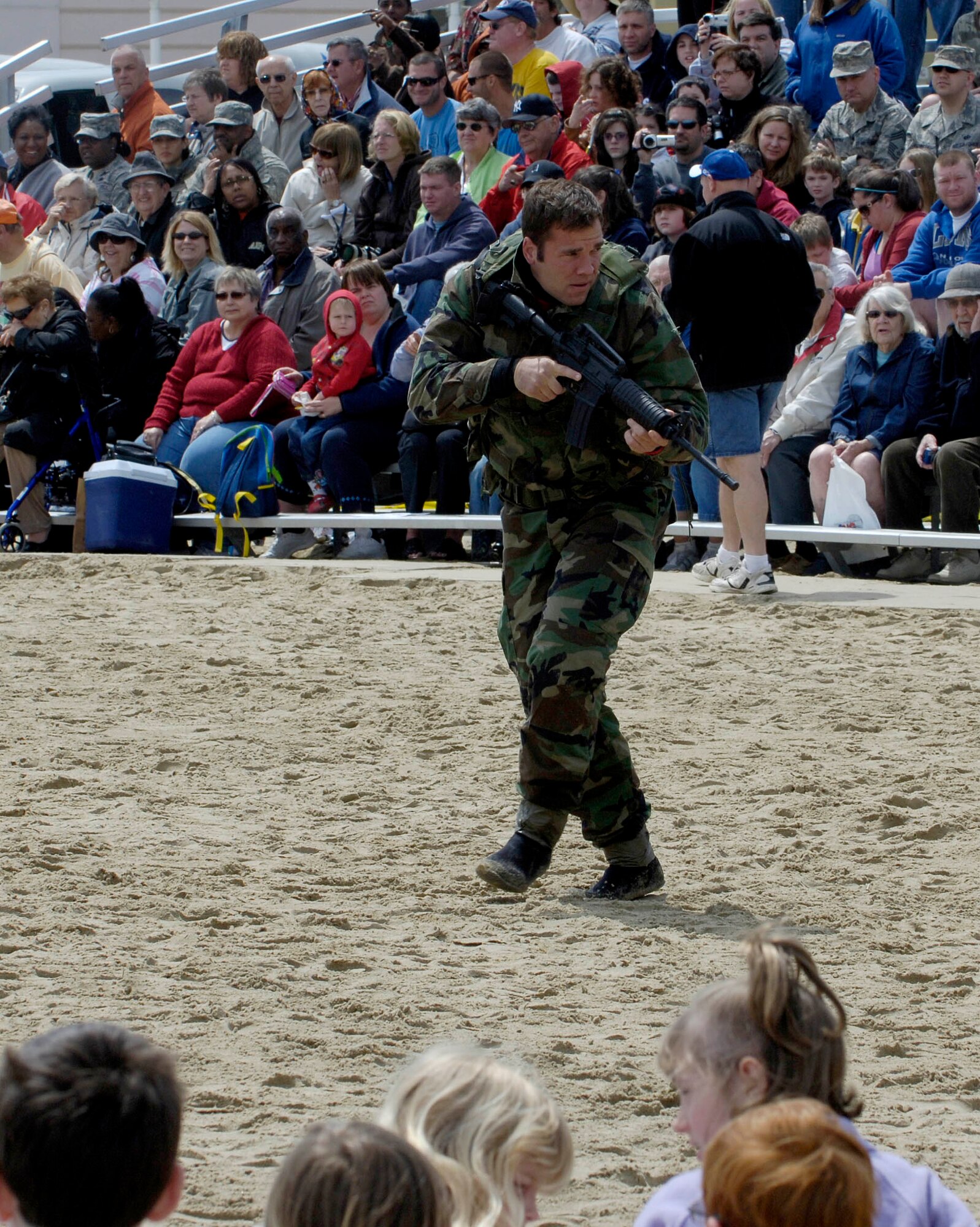 LANGLEY AIR FORCE BASE, Va. -- Capt. John Hensz 1st Operation Support Squadron, simulates being stranded in enemy territory during the Joint Air Power Demonstration at the Virginia Beach boardwalk April 22.  The demonstration showcased the critical role air power plays in the joint fight. This is one of many events going on in the Hampton Roads area as the Air Force members say "thank you" to the community during Hampton Roads Air Force Week.  (U.S. Air Force photo/Airman Rebecca Montez)