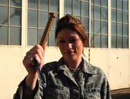 Staff Sgt. Regina Prendes, Maintenance Supply Liason, 433rd Airlift Wing, found the Golden Bolt during the Monday morning Foreign object Damage prevention walk after the 'B' Unit Training Assembly. The walk is held every Monday and the golden bolt is hidden somewhere on the flight line on Mondays after a UTA. (U.S. Air Force Photo/ Airman Brian McGloin)