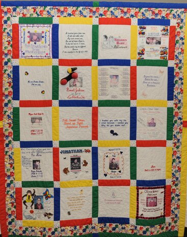 As part of Child Abuse Prevention Month, a "Shaken Baby Quilt"  was displayed at the Nellis Air Force Base Library, April 21. The quilt is on loan from the Shaken Baby Alliance and is dedicated to the memory of those children who have died as a result of child abuse. Nellis AFB is the only Department of Defense facility to display the quilt this year. (U.S. Air Force photo by Airman 1st Class Brett Clashman/Released)
