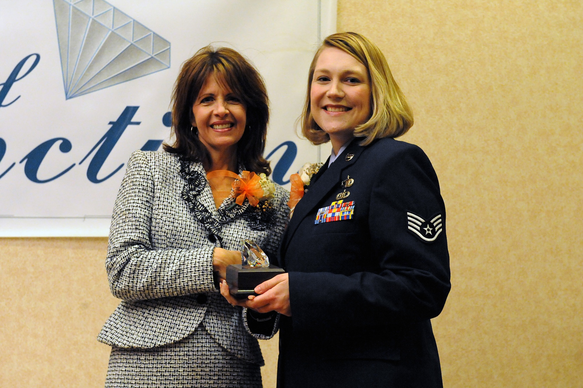 MINOT, N.D. -- The Young Women's Christian Association of Minot awarded two military 'Woman of Distinction' awards to an enlisted and military member of Minot Air Force Base April 21. Several nominees were honored, but Staff Sgt. Amanda J Regler, manpower analyst, 5th Force Support Squadron, received the award for the enlisted category. First Lady of North Dakota, Mikey L. Hoeven, presented the award. (U.S. Air Force photo by Senior Airman Kelly Timney)
