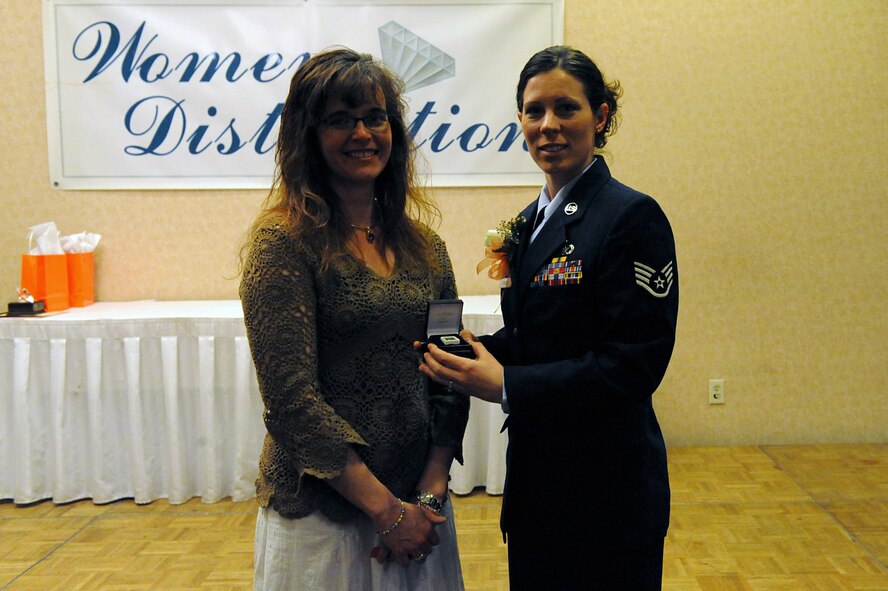 MINOT, N.D. -- Staff Sgt. Susan Lawson, 5th Civil Engineer Squadron project manager, receives an $1800 diamond at the awards ceremony for the Young Women's Christian Association of Minot April 21. Sergeant Lawson was a nominee in the enlisted category, but said winning the diamond was "better than an award." Presenting the diamond was the spouse of a local jeweler. (U.S. Air Force photo by Senior Airman Kelly Timney)
