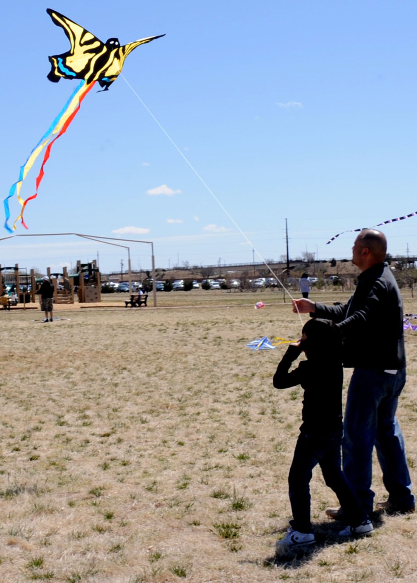 CANNON AIR FORCE BASE N.M.-- A family gathers at Doc Stewart Park for the annual Kite Karnival April 18. The event attracts people from the surrounding area to display their kite flying expertise. (U.S. Air Force photo/Airman 1st Class Evelyn Chavez)