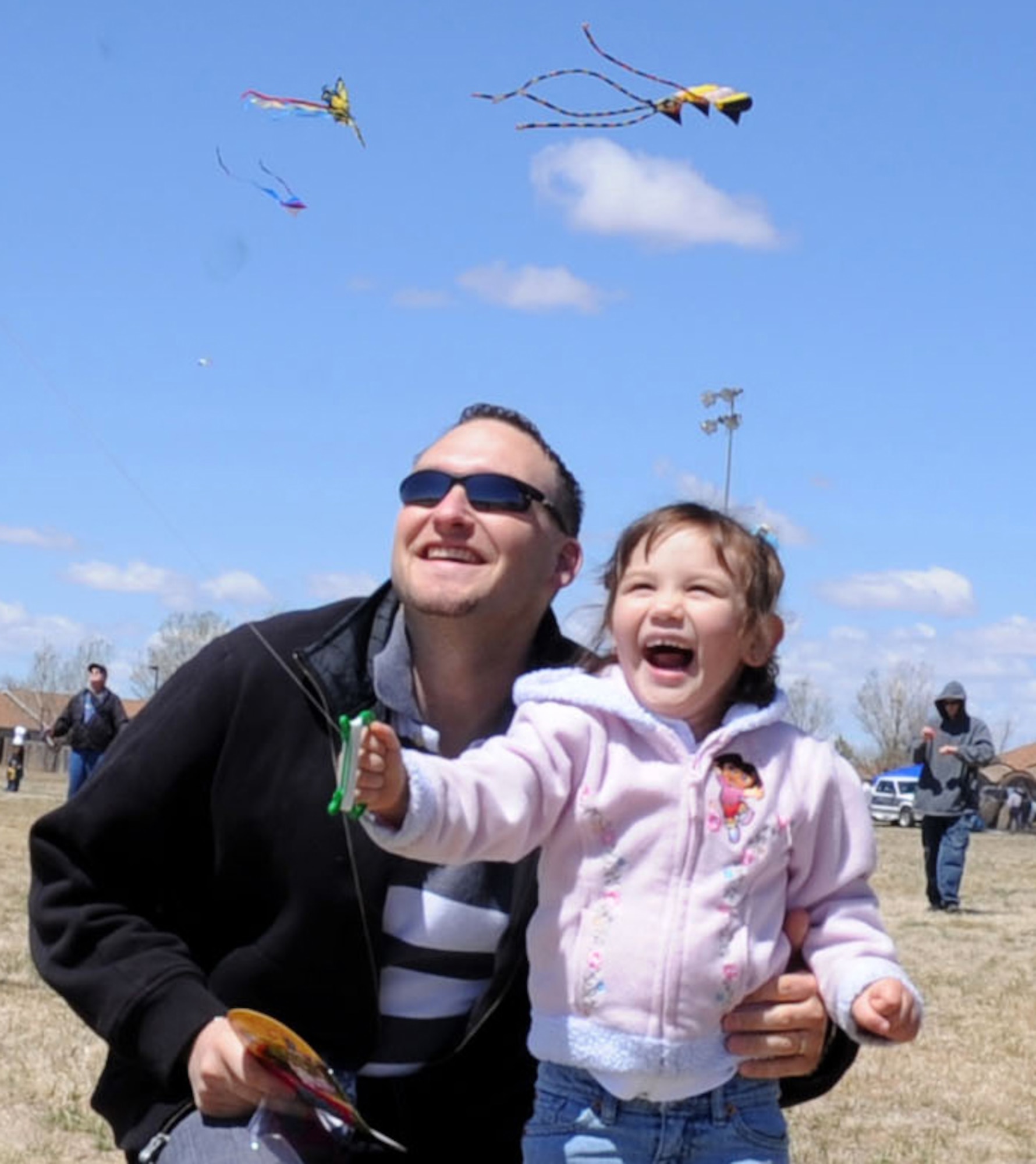 CANNON AIR FORCE BASE N.M.--Shaffin Baldwin helps his daughter Shaylynn  fly a kite during the annual Kite Karnival April 18 at Doc Stewart Park. The Kite Karnival is a Community Center "Let's Celebrate!" trademark event that attracts people from the surrounding area to experience kite flying at its best. (U.S. Air Force photo/Airman 1st Class Evelyn Chavez)
