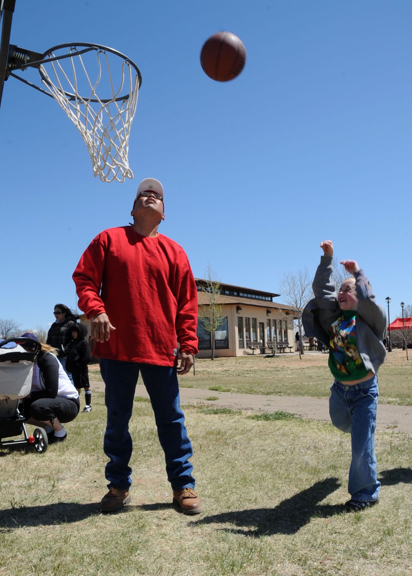 CANNON AIR FORCE BASE N.M. -- Robert Glockner shoots hoops at a booth during the annual Kite Karnival April 18 at Doc Stewart Park. Base and area residents gathered at the park to test their kite flying skills and participate in other events at the community event. (U.S. Air Force photo/Airman 1st Class Evelyn Chavez)