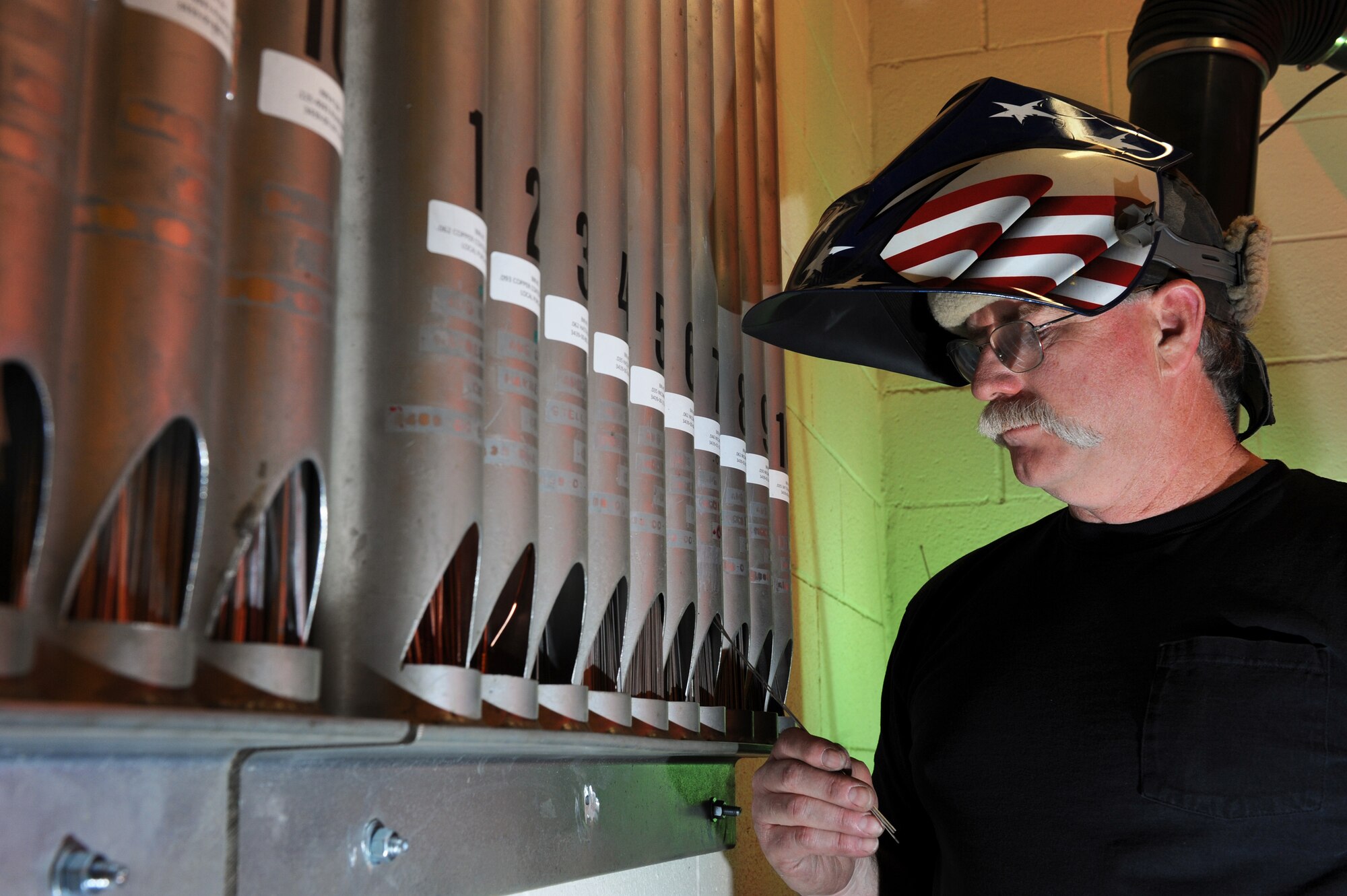 Randy Cherland selects the proper welding beam to match the metal specifications for the welding job April 16 at Nellis Air Force Base, Nev.  He is a metals technician with the 57th Components Maintenance Squadron here.  (U.S. Air Force photo/Senior Airman Nadine Y. Barclay)