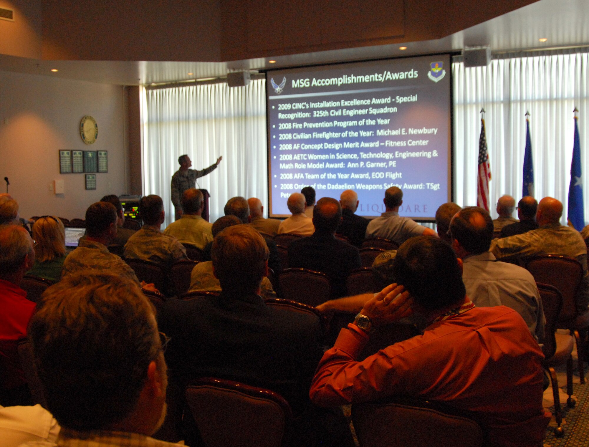 (Foreground) Members of the Tyndall Military Affairs Committee listen as Brig. Gen. Darryl Roberson, 325th Fighter Wing commander, addresses them April 21 at the Heritage Club here on the "State of Tyndall." The purpose of the address was not only to inform the committee members on successes and missions of base units, but also to showcase current base improvement projects. There were more than 40 committee members present at the event. (U.S. Air Force photo/Lisa Norman)