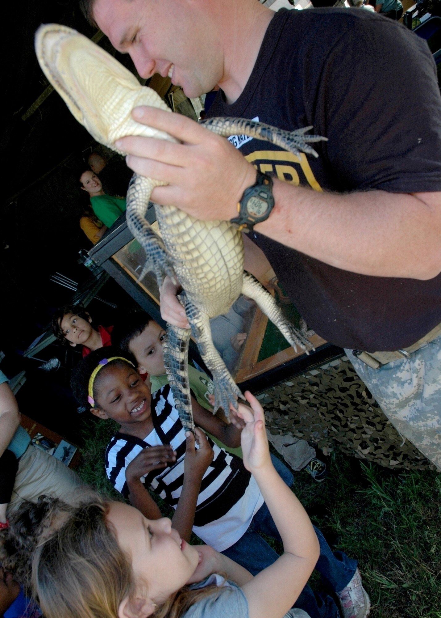 EGLIN AIR FORCE BASE, Fla. -- Jada Bard (touching), and Ciara Lewis get exposure to some of the wildlife that exist in the Northwest Florida ecosystem at the Earth Day event hosted at Cherokee Elementary School April 20. The event was designed to give children the opportunity to get hands-on experience with animals they normaly wouldn't get to see and learn the importance  of protecting the environment. (U.S. Air Force photo/ Airman Anthony Jennings)
