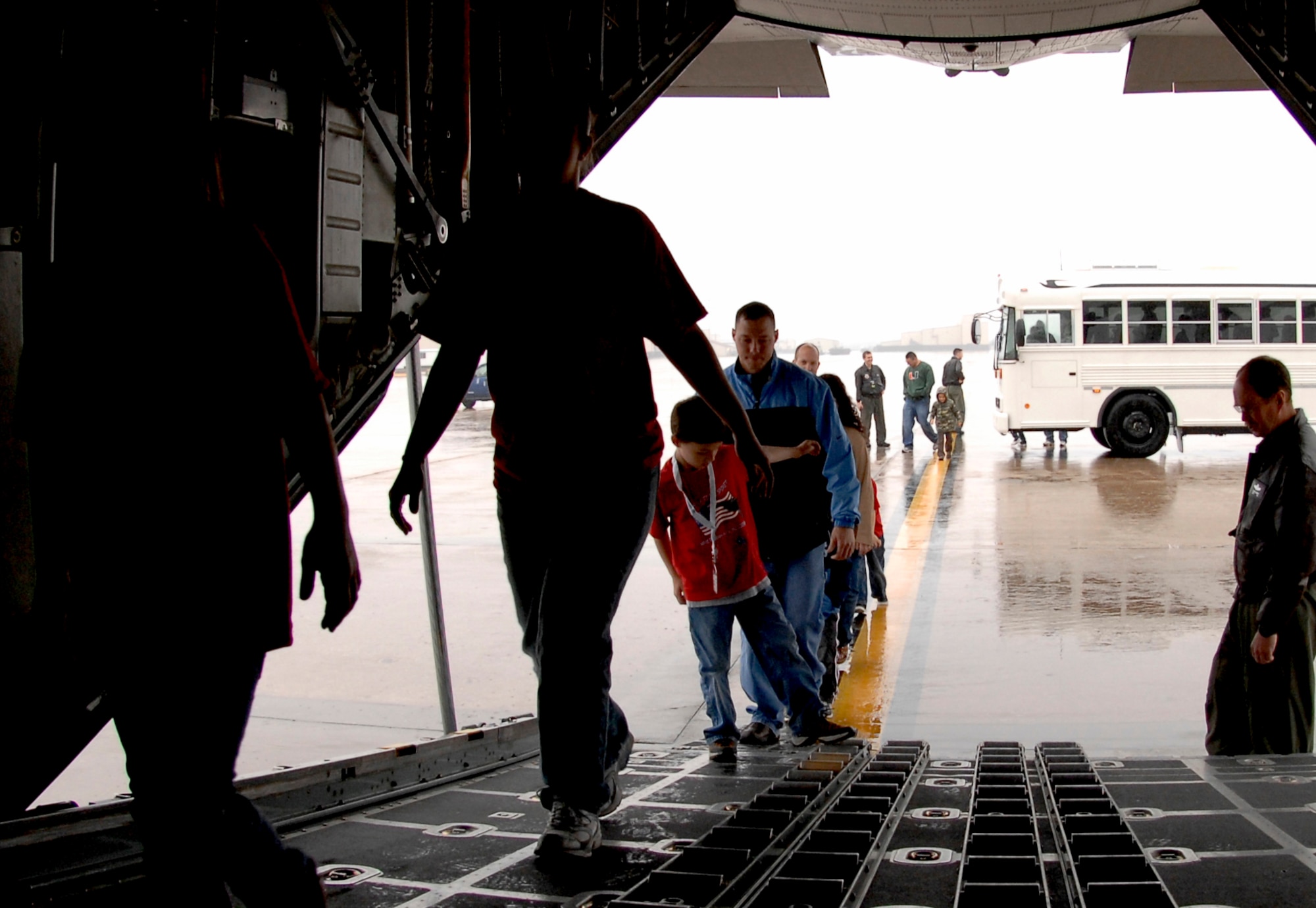 WHITEMAN AIR FORCE BASE, Mo. - Young "Airmen" board a C-130 from the 139th Airlift Wing in St. Joseph, Mo. April 18 during Operation Spirit. Operation Spirit is a simulated deployment line for school-aged kids that allows children to experience what their military parents go through during a deployment. The "Airmen" were accompanied by their parents and received goodies form several base agencies. (U.S. Air Force photo/Staff Sgt. Jason Barebo)