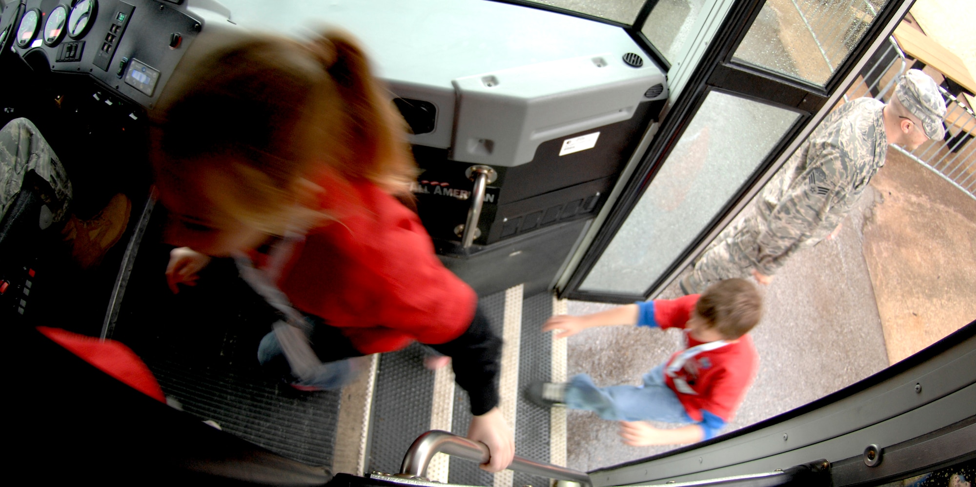 WHITEMAN AIR FORCE BASE, Mo. - Young "Airmen" load onto a bus April 18 during Operation Spirit as they prepare to go to the flightline and board an awaiting C-130. The "Airmen" participated in a mock deployment to Kabul, Afghanistan. Operation Spirit is a simulated deployment line for school-aged kids that allows children to experience what their military parents go through during a deployment. The "Airmen" were accompanied by their parents and received goodies form several base agencies. (U.S. Air Force photo/Staff Sgt. Jason Barebo)