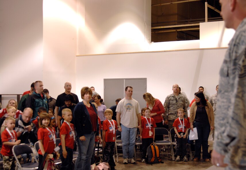 WHITEMAN AIR FORCE BASE, Mo. - Young "Airmen" stand at attention April 18 as Chief Master Sgt. Brian Hornback, 509th Bomb Wing command chief, teaches them how to stand at attention for the arrival of the base commander during Operation Spirit. Operation Spirit is a simulated deployment line for school-aged kids that allows children to experience what their military parents go through during a deployment. The "Airmen" were accompanied by their parents and received goodies form several base agencies. (U.S. Air Force photo/Staff Sgt. Jason Barebo)