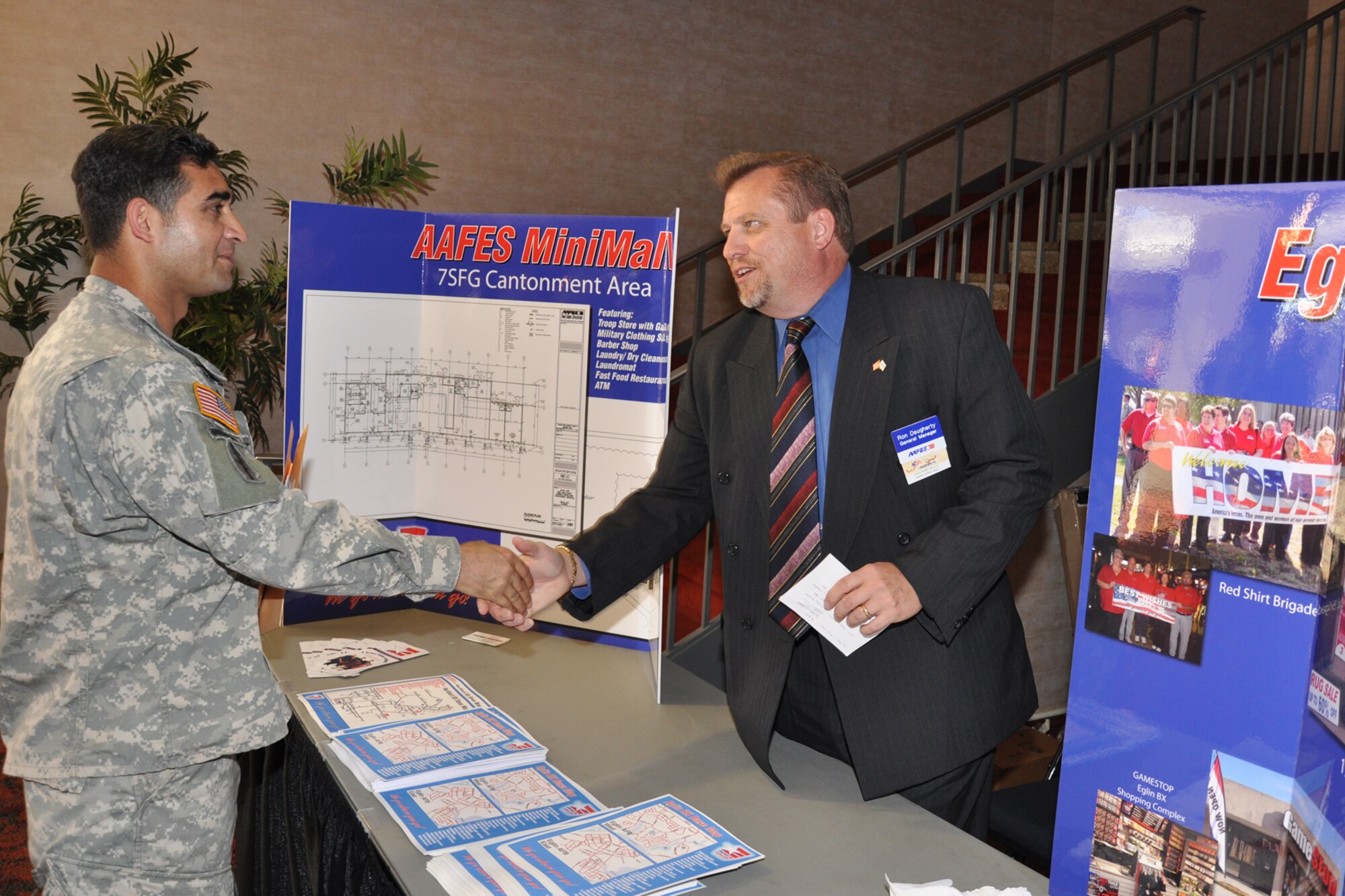 FORT BRAGG, North Carolina -- Ron Daugherty, General Manager of the Army Air Force Exchange Service, talks to a Soldier about what?s available at Eglin AAFES and that new shoppette will be built within the 7th Special Force Group cantonment area.  More than 30 representatives from Eglin traveled to Fort Bragg, April 16-18, to present 7th SFG(A) members and spouses with information about the base and Northwest Florida.  More than 1,000 people attended the briefings. (Photo by Master Sgt. Andrew Leonhard)