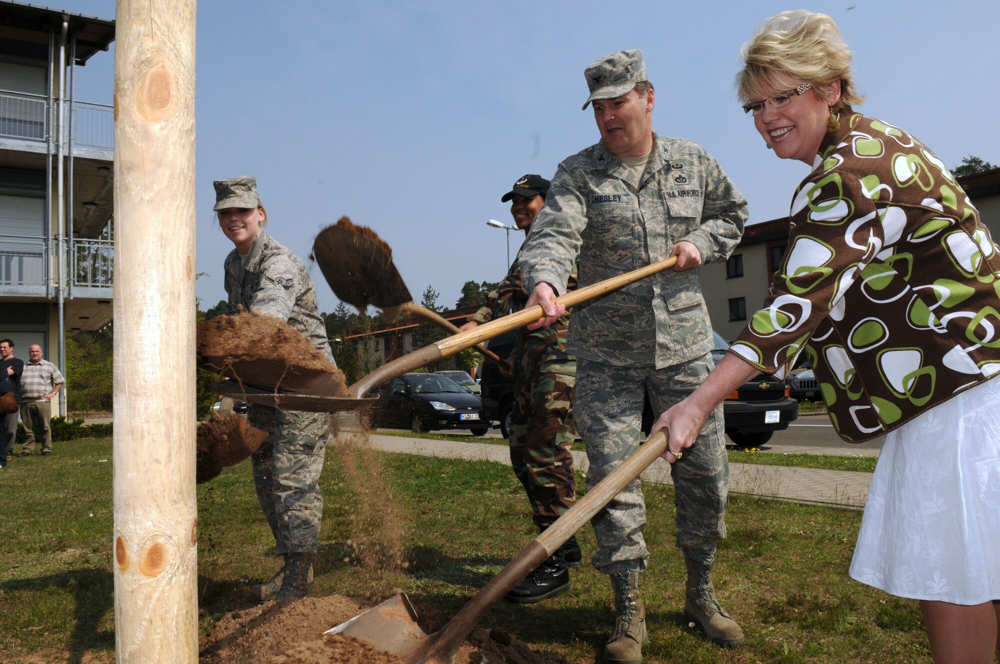 From left to right, Airman Julia Alf, 435th Medical Operations Squadron medical technician; Airman 1st Class Aquarius Benoit, 435th MDOS medical technician; Col. Gary Chesley, 435th Civil Engineer Group commander; and Tammy Hanesworth, 435th Civil Engineer Squadron unaccompanied housing chief, celebrate Earth Day with a tree planting April 22 in front of the Ramstein Air Base medical dormitories. The first Earth Day was celebrated by about 20 million people in 1970. (U.S. Air Force photo by Senior Airman Amanda Dick)