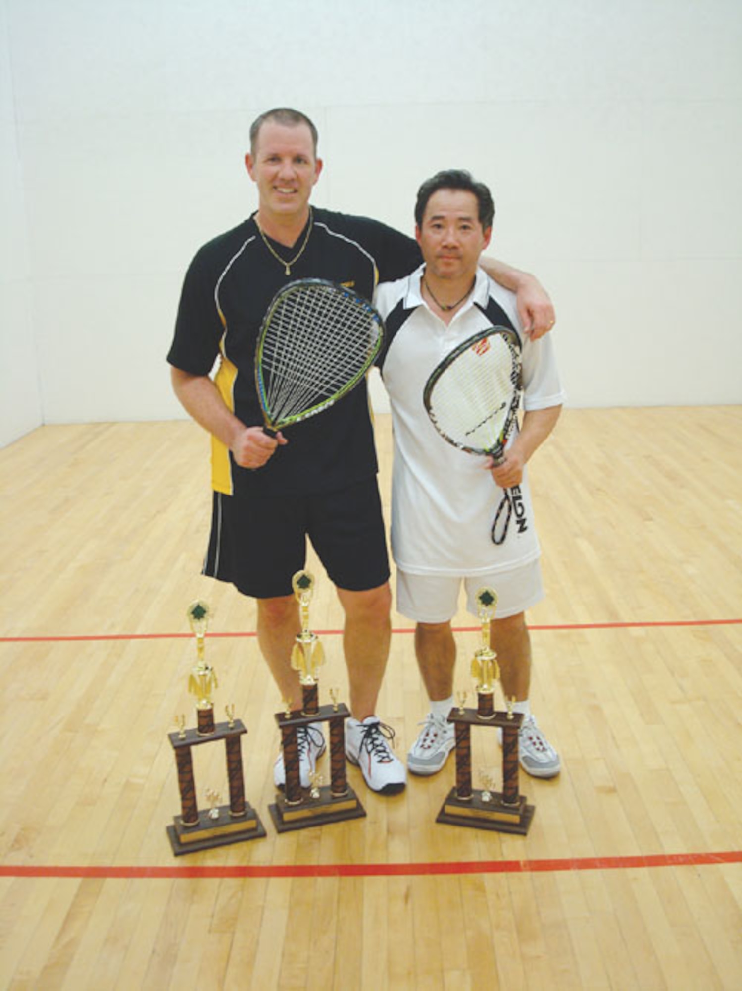 SCOTT AIR FORCE BASE, Ill. --Jerry Turley (left) won first place last week in the racquetball tournament held at James Gym.  Mr. Cheng won second place. (U.S. Air Force photo/Steve Berry) 