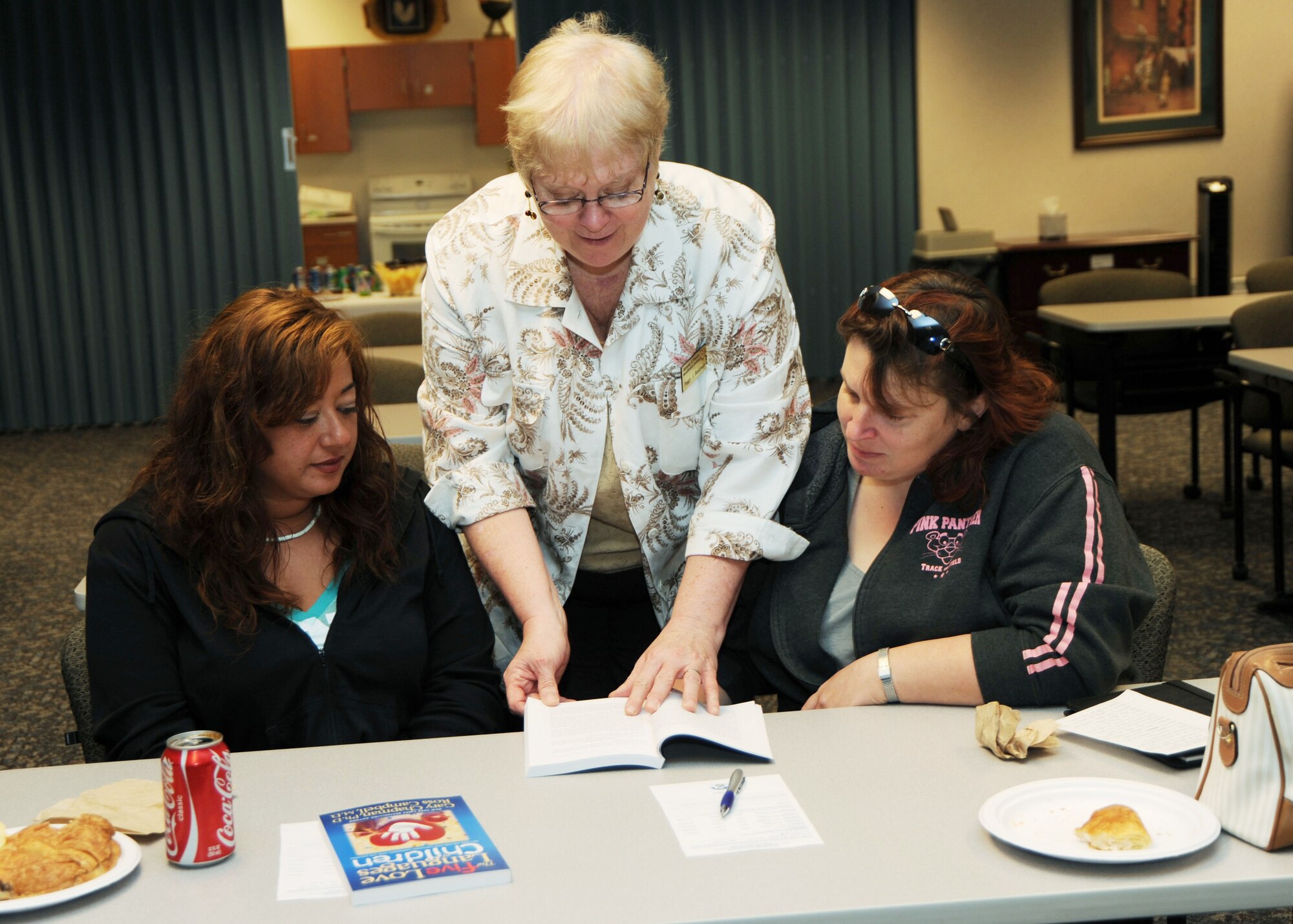 SCOTT AIR FORCE BASE, Ill. --Peggy Beauvais, of the Airman and Family Readiness Center, explains the five different communication styles of children to Dawn Taira and Alex Sturgill whose spouses work for the 375th Security Forces Squadron.  The class was held April 16 at the A&FRC.  It enabled parents to better communicate with their children by learning the various communication styles children use. (U.S. Air Force photo/Tech. Sgt. Michelle Larche) 