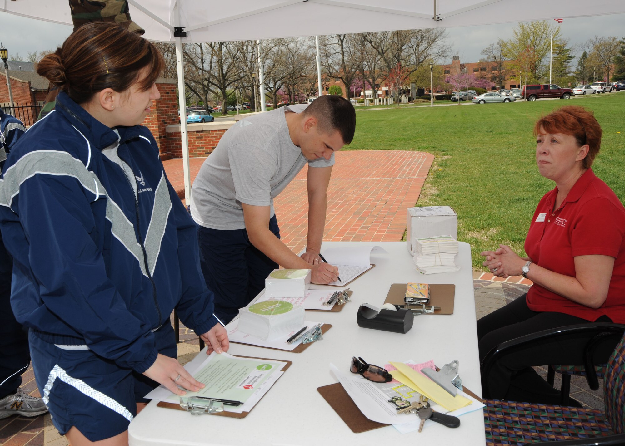 SCOTT AIR FORCE BASE, Ill. --Buffy McKinney (seated), of the American Heart Association, explains details of the Heart Walk to Senior Airman Danielle Gooch, a member of the 375th Medical Group.  The Heart Walk will be May 2 at Busch Stadium in St. Louis. (U.S. Air Force photo/Tech. Sgt. Michelle Larche) 