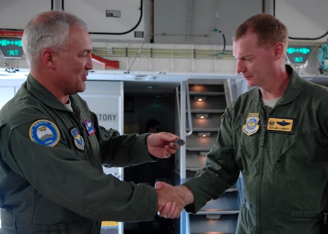Maj. Gen. Erwin F. "Erv" Lessel III hands over the key to Charleston's newest C-17 to Col. John "Red" Millander April 17. This is the seventh out of ten new C-17s Charleston AFB will receive. General Lessel is the Director of Plans, Programs, Requirements and Assessments, and the Director of the San Antonio Joint Program Office, Headquarters Air Education and Training Command, Randolph AFB, Texas. Colonel Millander is the 437th Airlift Wing Commander. (U.S. Air Force photo/Senior Airman Katie Gieratz)