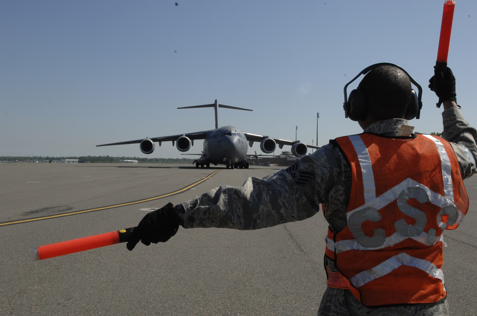 Staff Sgt. John Green marshals in Maj. Gen. Erwin F. "Erv" Lessel III as he taxis in the newest C-17 addition to Charleston AFB April 17. This is the seventh out of ten new C-17s Charleston AFB will receive. General Lessel is the Director of Plans, Programs, Requirements and Assessments, and the Director of the San Antonio Joint Program Office, Headquarters Air Education and Training Command, Randolph AFB, Texas. Sergeant Green is a crew chief with the 437th Aircraft Maintenance Squadron. (U.S. Air Force photo/Senior Airman Katie Gieratz)