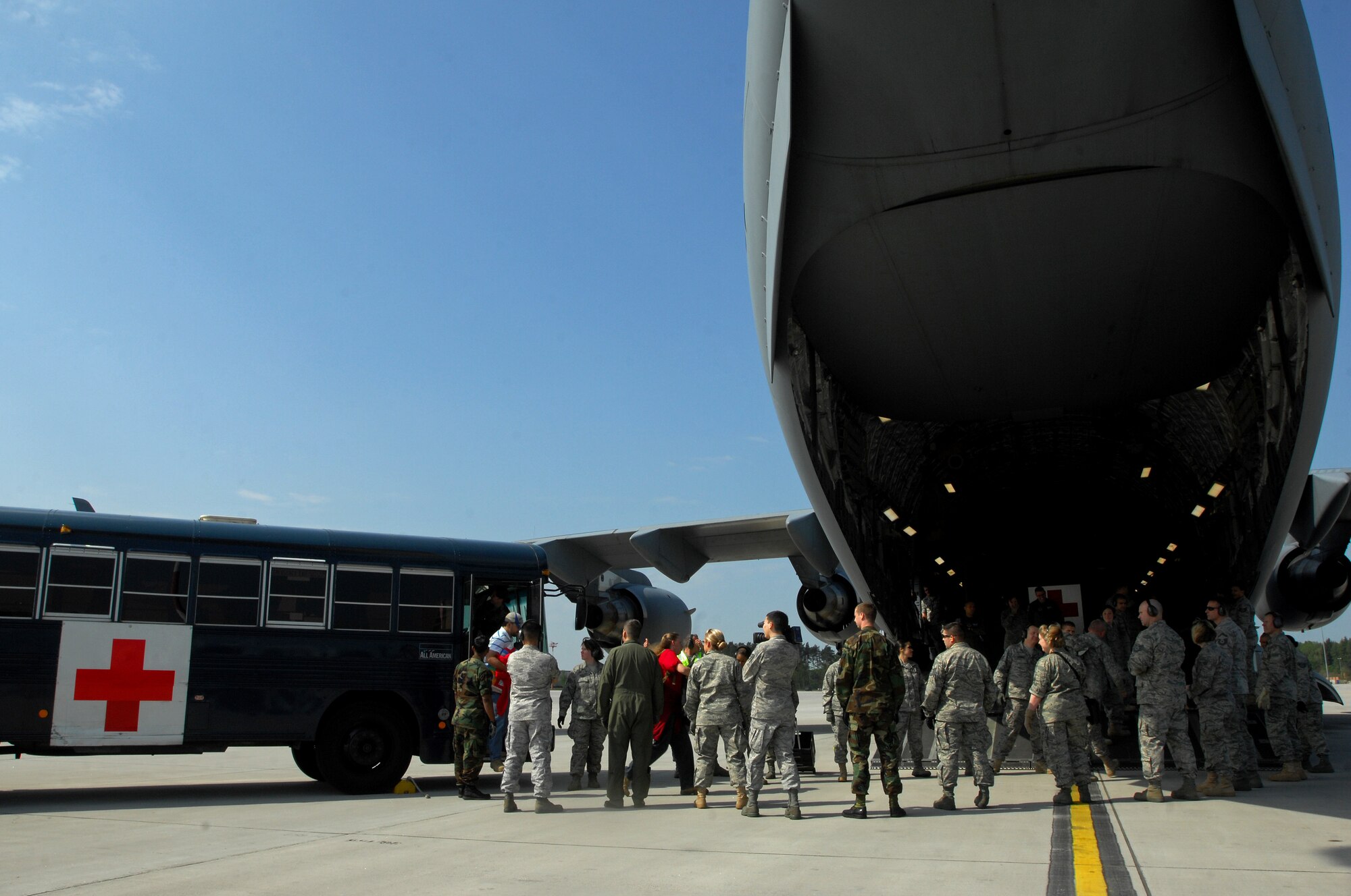 Air Force members from the 435th Aeromedical Squadron load wounded military members returning from the Area of Operation onto a C-17 Globemaster III for transport to the continental United States for further treatment. Members of the 86th Aeromedical Evacuation Squadron provided patient care for the duration of the flight. (U.S. Air Force photo by Airman 1st Class Kenny Holston)