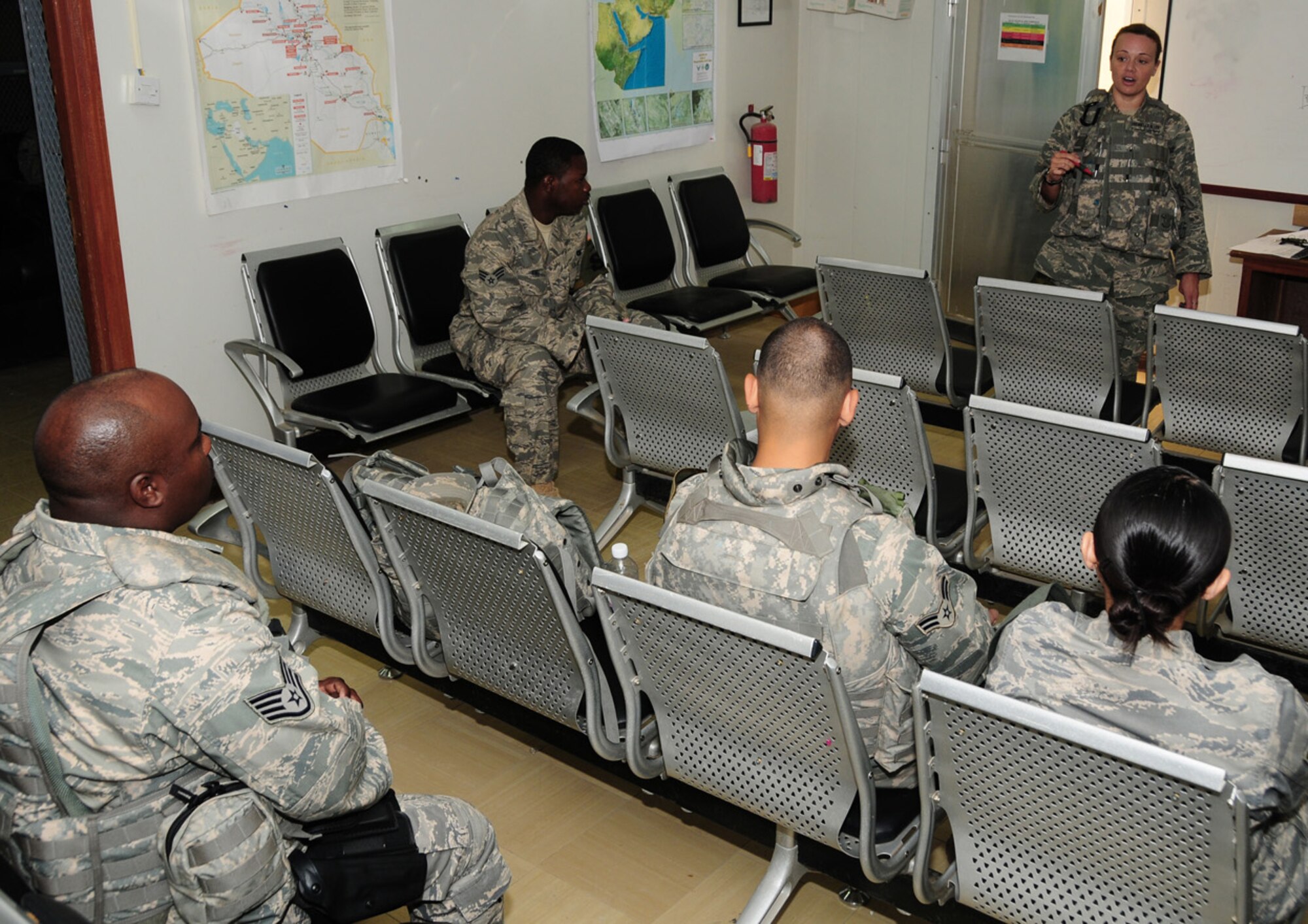 Staff Sgt. Valerie Brunelle-Allen answers last minute questions before arming up for a mission April 15 at an air base in Southwest Asia. She is a security escort team member with the 386th Expeditionary Security Forces Squadron. When not on a mission, the SET members spend their time training or reviewing procedures. (U.S. Air Force photo/Senior Airman Courtney Richardson)