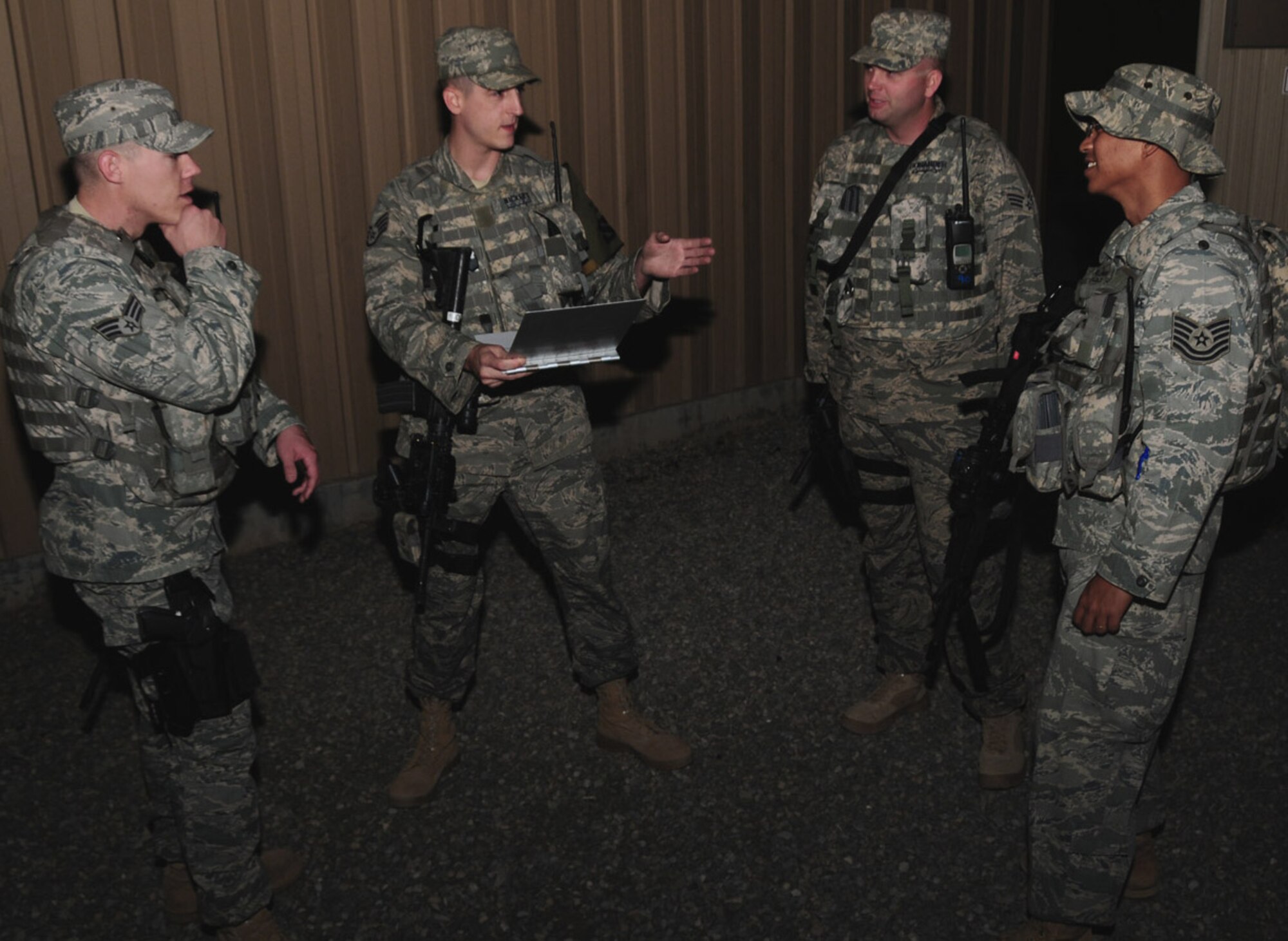Security escort team members assigned to the 386th Expeditionary Security Forces Squadron prepare April 15 for another mission at an air base in Southwest Asia. The SET is responsible for the safety and security of moving people from one destination to another. (U.S. Air Force photo/Senior Airman Courtney Richardson)