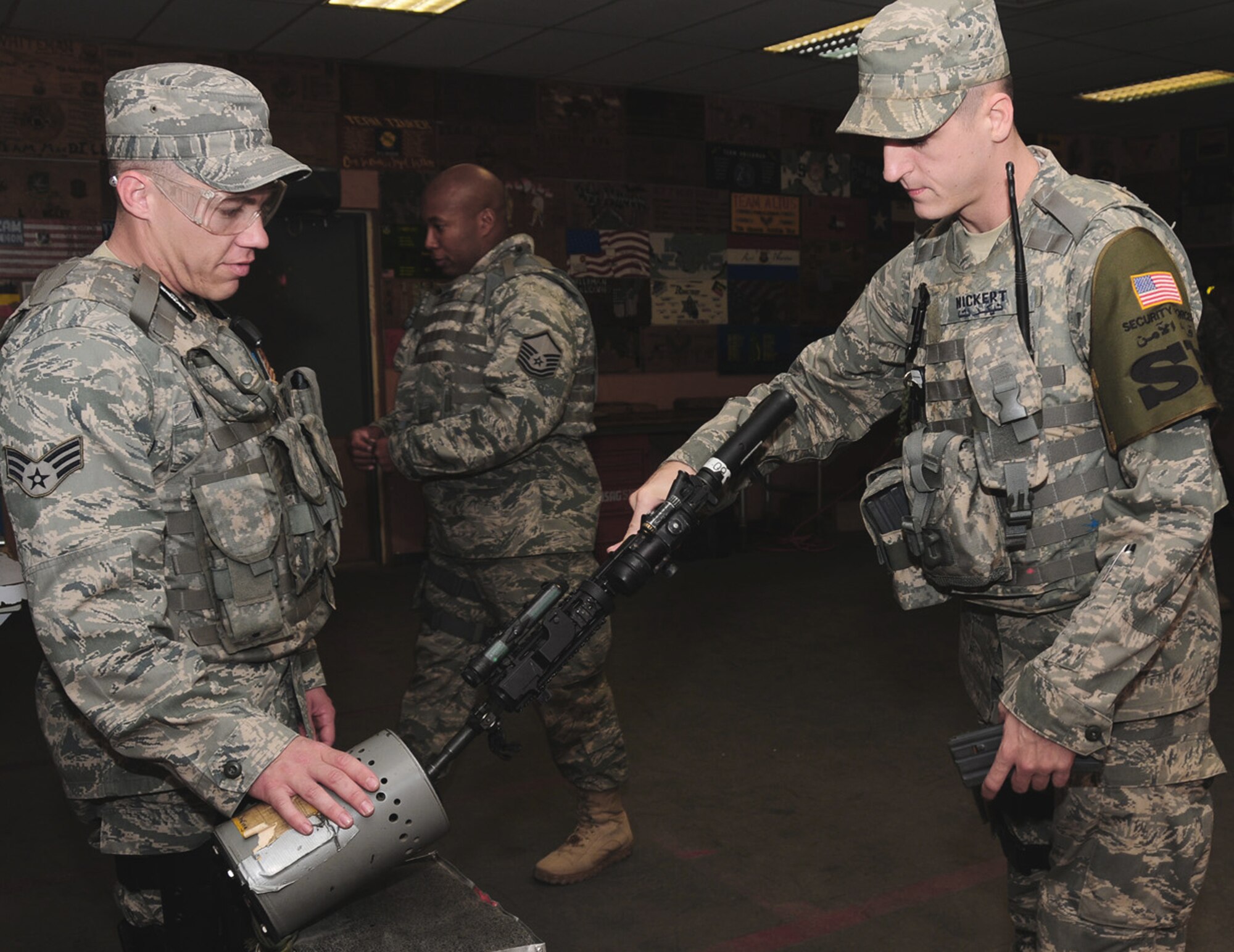Staff Sgt. Nicholas Nickert (right) arms up and clears his weapon before heading out on a mission April 15 at an air base in Southwest Asia. He is a security escort team member assigned to the 386th Expeditionary Security Forces Squadron.  SET team members are specially trained before deployment in defensive driving and personnel protection. (U.S. Air Force photo/Senior Airman Courtney Richardson)