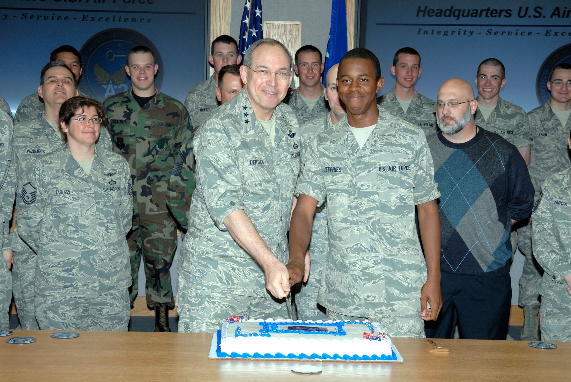 Lieutenant General David Deptula, Deputy Chief of Staff, Intelligence, Surveillance, and Reconnaissance at Headquarters Air Force, and Airman Basic John Jeffries, a Network Intelligence Analysis student with the 316th Training Squadron, cut the cake inaugurating the first class to enter the Intelligence Fundamentals Course at Goodfellow Air Force Base, Texas. (U.S. Air Force photo by Lou Czarnecki)
