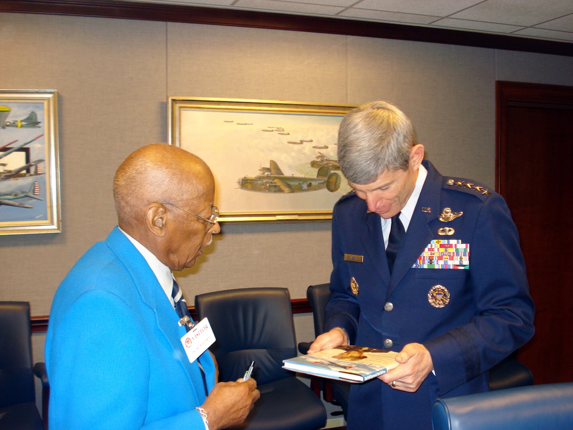 Chief of Staff of the Air Force, Norton A. Schwartz, and Lt. Col. (ret.) Alexander Jefferson, an original Tuskegee Airman, chat in the commander's conference room. Jefferson, a former WWII POW (held in a Nazi camp), gave the commander a copy of his book.  (U.S. Air Force photo/Maj. Andra P. Higgs) 