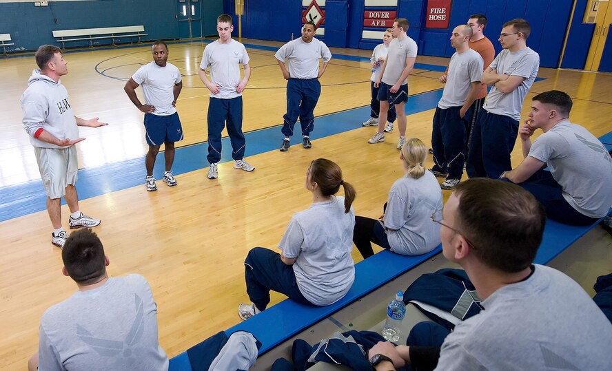 (Left) John Walters, 436th Aerospace Medicine Squadron Health and Wellness Center exercise physiologist and Physical Training Leader instructor, teaches Dover Airmen how to lead their squadron in the fight by being fit to meet expeditionary mission requirements at the Fitness Center during a PTL class. (U.S. Air Force photo/ Jason Minto)