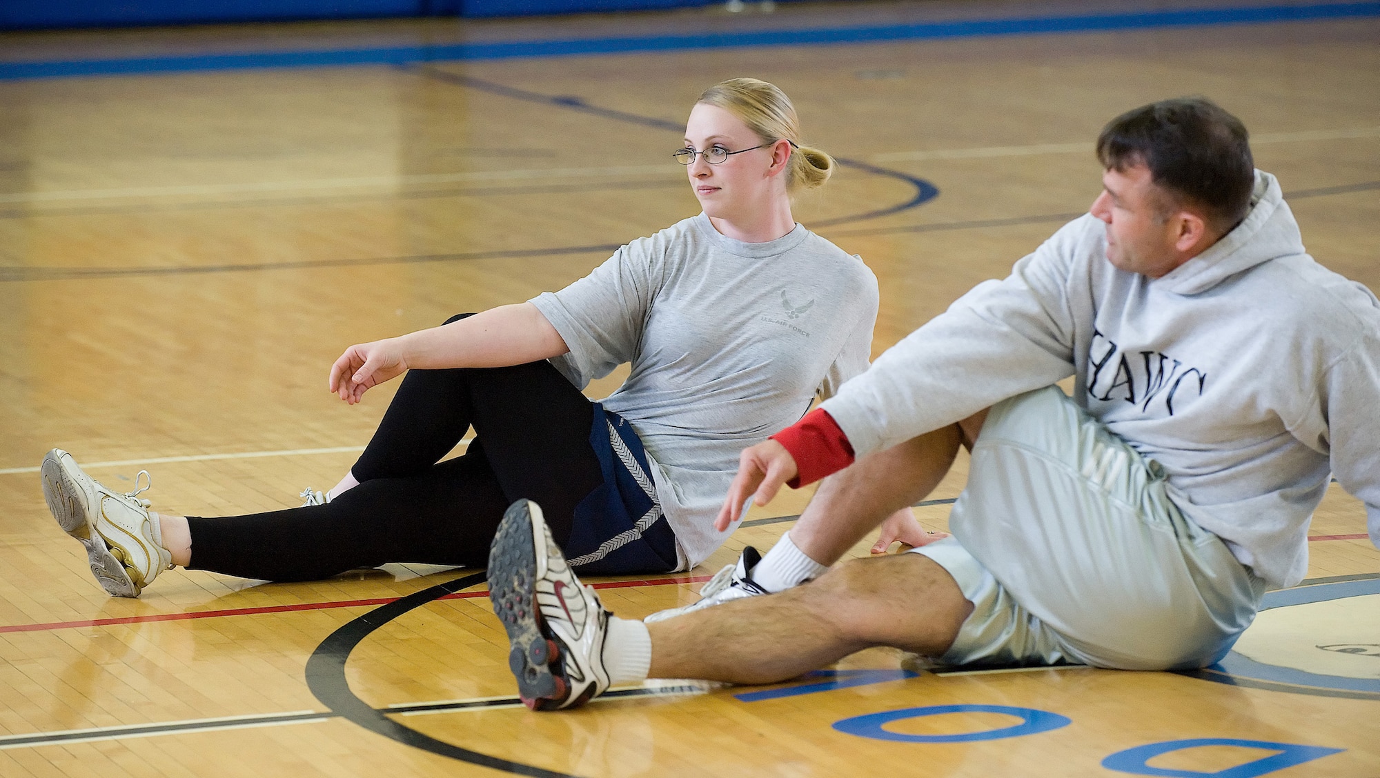 (Left to right), Senior Airman Jean Lawrence, 436th Operations Support Squadron, demonstrates a stretch technique with John Walters, 436th Aerospace Medicine Squadron, during a Physical Training Leader class at the Fitness Center. (U.S. Air Force photo/ Jason Minto)