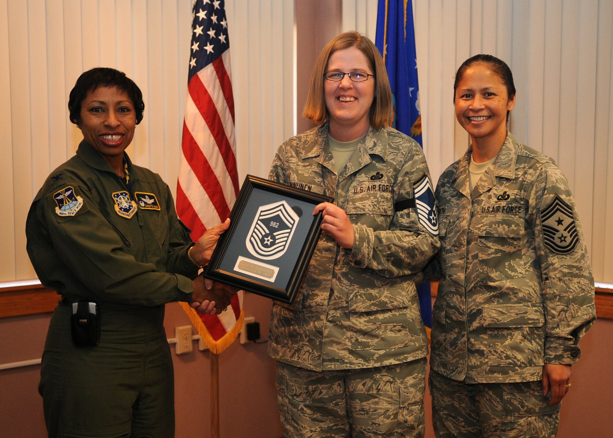 BUCKLEY AIR FORCE BASE, Colo. -- Master Sergeant Lisa Kinnunen is congratulated by Col. Charlotte Wilson, 460th Space Wing Vice Commander and 460th Space Wing Command Chief Master Sergeant Arleen Heath, for her selection to Senior Master Sergeant.   Sergeant Kinnunen was recently one of 1,450 master sergeants to receive the news and the only one at Buckley.  (U.S. Air Force photo by Senior Airman Randi Flaugh)