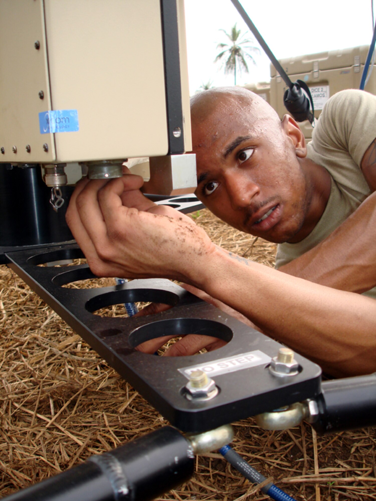 Senior Airman Darren Pleasant, 21st Air Mobility Operation Squadron satellite communication specialist, connects a wire to the Universal Satellite Communication disc at a deployed location in West Central Africa. Members of the 21st AMOS provide satellite communication, including Internet communication and phone-service capabilities, to the members of the U.S. Navy 11th Construction Mobile Team Battalion in support of Africa Partnership Station 2009. The APS 09 is a joint multi-national initiative under the auspices of Naval Forces from Europe and Africa, which is designed to work in cooperation with United States, European and African partners to enhance maritime safety, provide humanitarian assistance, and increase security on the African continent. (U.S. Air Force photo/Staff Sgt. Francis Lalic)