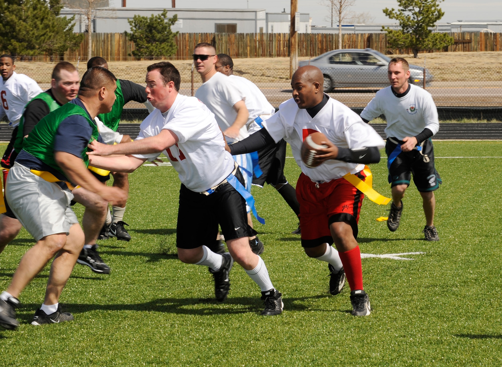 BUCKLEY AIR FORCE BASE, Colo. -- Sean Collins, 460th Force Support Squadron, looks for an opening to throw a pass during the Air Force Assistance Fund bowl here, April 20.  The game and burger burn raised over $1,000 for the fund. The competition included junior enlisted versus senior enlisted and officers.  The junior enlisted team won in triple overtime. (U.S. Air Force photo by Senior Airman Steve Czyz)