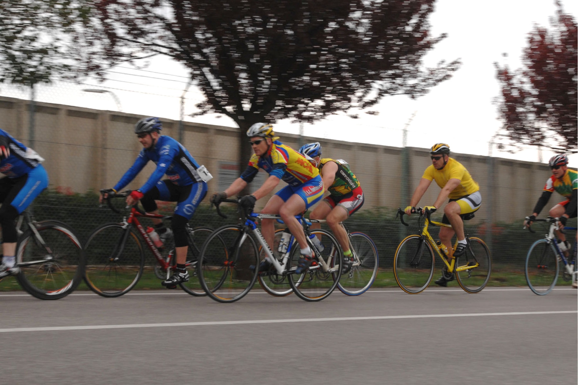 The lead group of riders in the men's 53 kilometer race held here April 19 take turns drafting off of each other as they push through the 25 mph head wind on the back-half of the course.  Christopher Fritzsche, center, wearing a blue/yellow jersey, from the 31st Civil Engineer Squadron, finished first with a time of 1:29.14 averaging 35.6 kilometers per hour.  The race is part of the 2009 U.S. Forces Europe Road Cycling Series.  (U.S. Air Force photo/Tech. Sgt. Michael O'Connor)