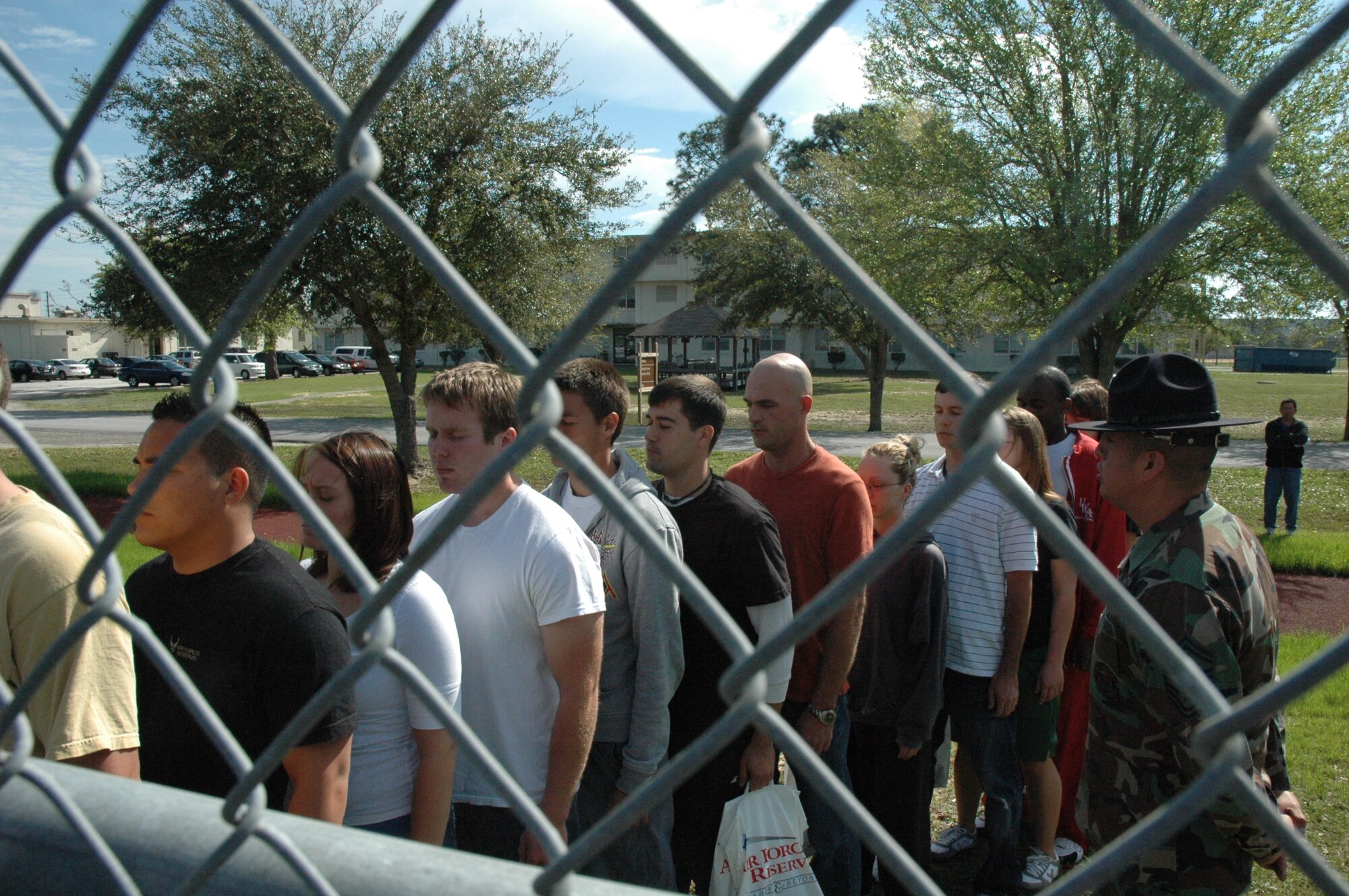 Senior Master Sgt. Steve Betancourt, 96th Medical Squadron, Eglin Air Force Base, commands recruits in the delayed entry program at Duke Field to close their eyes and imagine stepping off a bus at basic military training as they enter a fenced volleyball court.  Senior Master Sgt. Betancourt, a prior MTI of four years, volunteered his time during the April unit training assembly to speak to recruits in the delayed entry program and give them a taste of what they will experience in their first few hours arriving at basic military training, Lackland AFB, Texas. The program maintains contact with recruits awaiting their ship date to BMT while ensuring they are in compliance with the Air Force Reserve standards.  It also gives them the information and motivation to have a smoother transition from civilian to military life. (U.S. Air Force photo/ Senior Airman Jon McCallum)