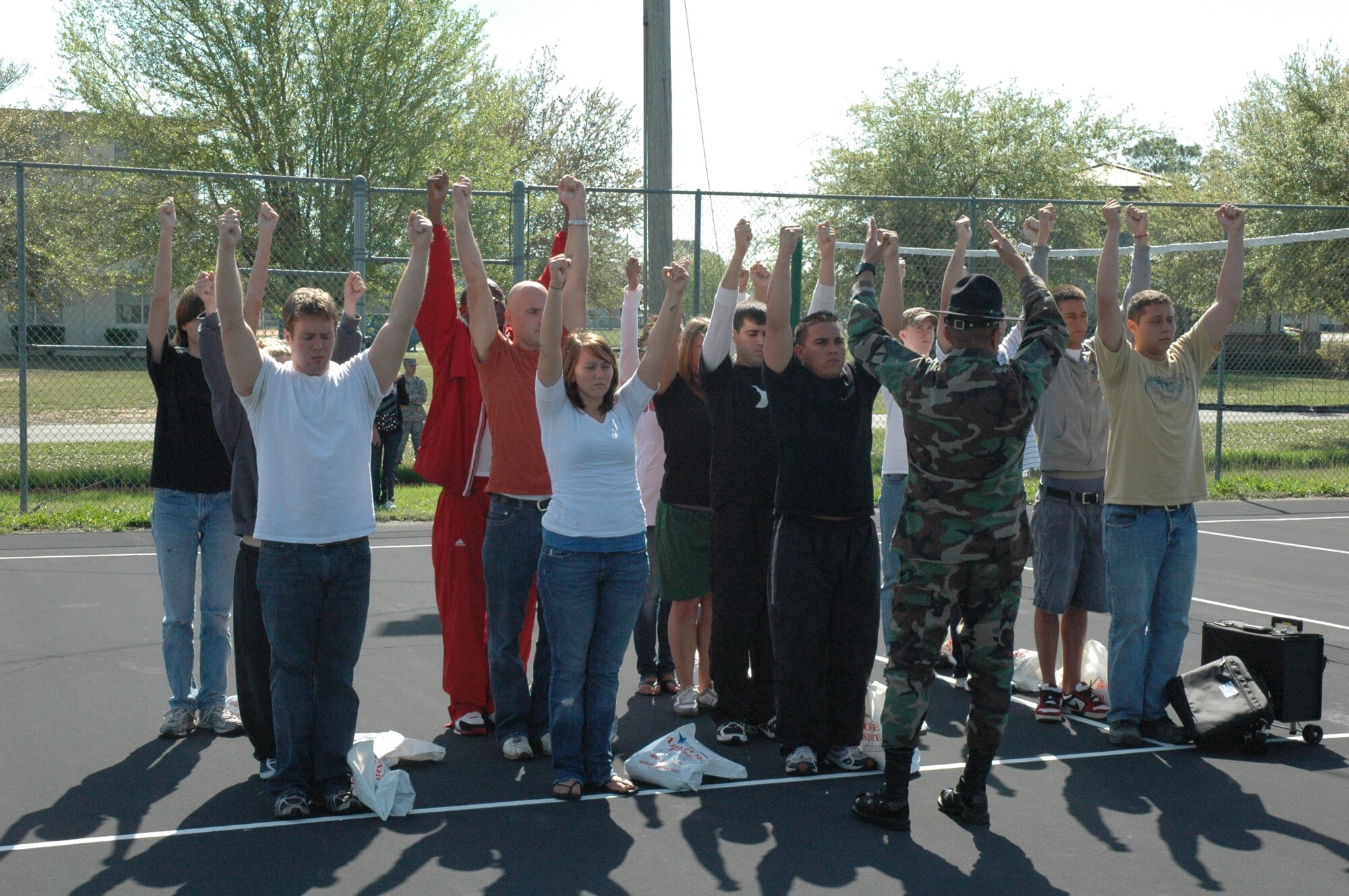 Senior Master Sgt. Steve Betancourt, 96th Medical Squadron, Eglin Air Force Base, commands a group of recruits at Duke Field to raise their hands high to prepare them to stand at the position of attention.  Sergeant Betancourt, a former military training instructor of four years, volunteered during the April unit training assembly to give DEP recruits a taste of what they will experience upon arriving at basic military training, Lackland Air Force Base, Texas. The DEP maintains contact with recruits awaiting their ship date to BMT while ensuring they are in compliance with the Air Force Reserve standards. It also gives recruits the information and motivation to have a smoother transition from civilian to military life. (U.S. Air Force photo /Senior Airman Jon McCallum)