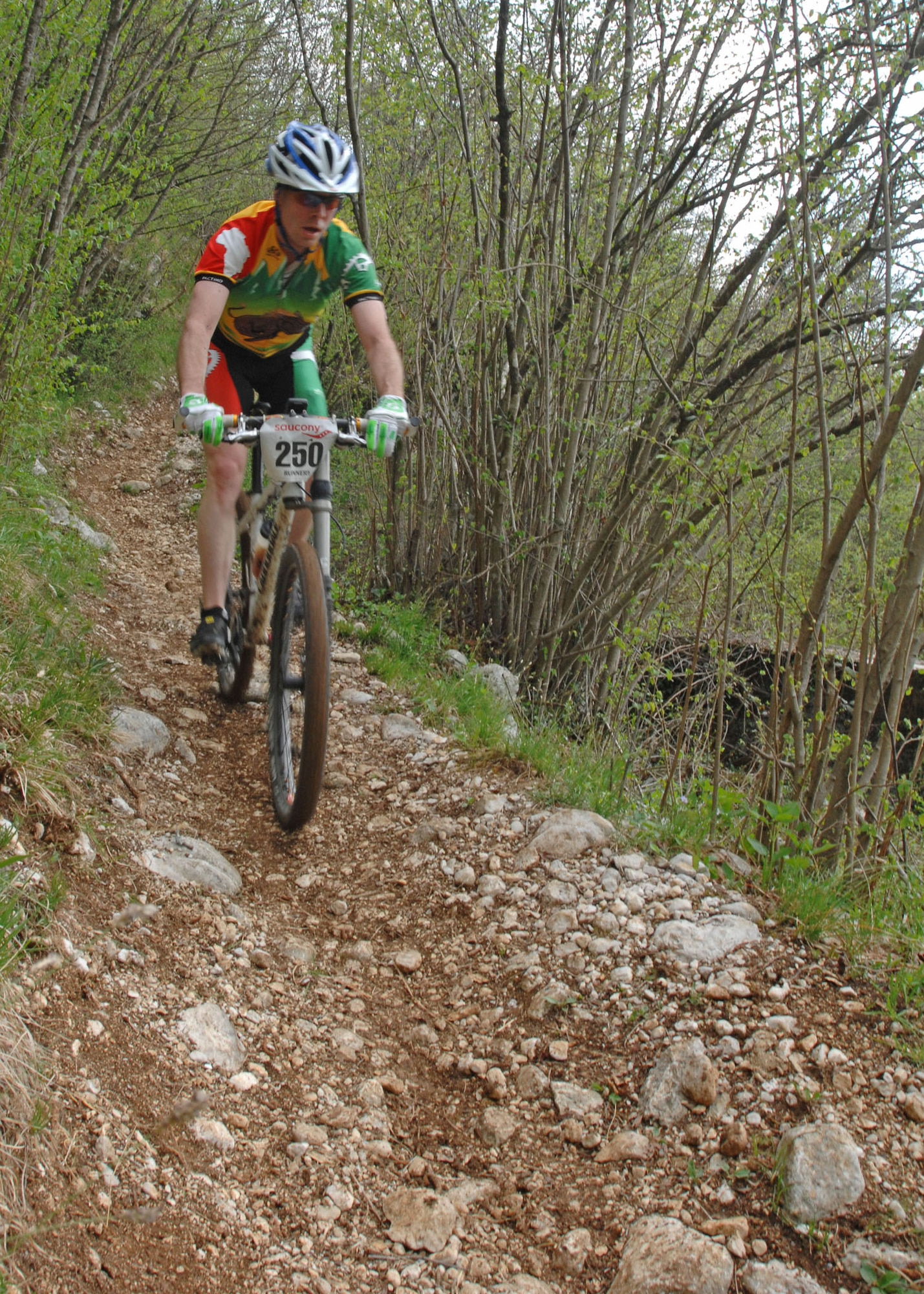 Andrew Overfield from U.S. Army Garrison in Stuttgart, Germany, navigates through one of several tricky downhill portions of the 6.25 kilometer loop at Camp Delta located at the base of the Dolomite Mountains near Aviano, Italy on April 18. Overfield won the 25 kilometer race with a time of 1:19.15.  Eighteen riders from Germany and Italy took part in the 2009 U.S. Forces Europe Mountain Bike Series race.  (U.S. Air Force photo/Tech. Sgt. Michael O'Connor)