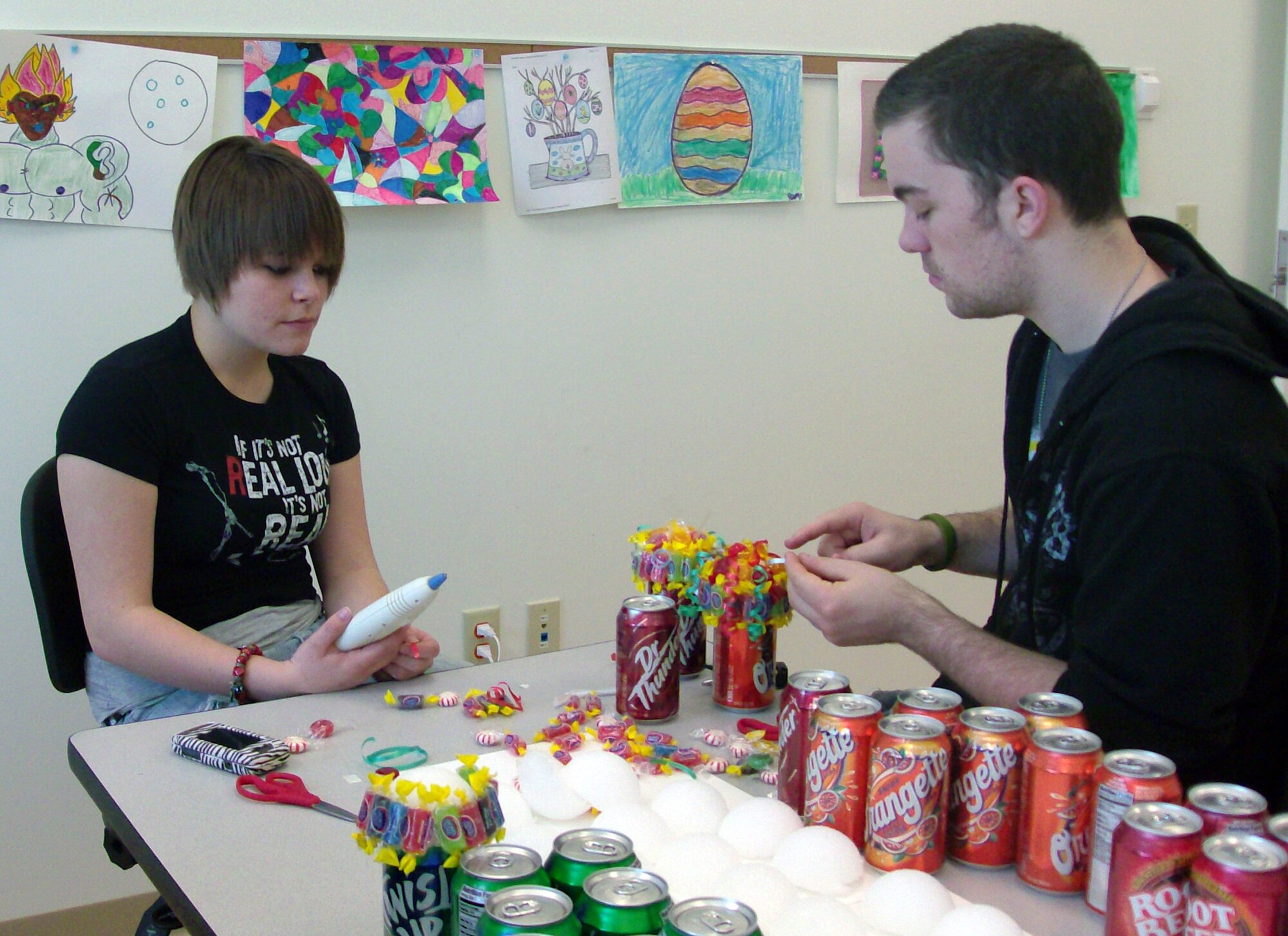 Ashley Brizendine and Michael Manchester, Jr., members of the Dover Air Force Base Youth Center, decorate soft drink cans, which were sold at the Children’s Carnival hosted at the Youth Center April 18.  The Children’s Carnival was held in honor of the Month of the Military Child. Ms. Brizendine, daughter of Master Sgt. Michael Grove, Jr., 436th Operations Support Squadron, was recently named Team Dover’s Youth of the Year for volunteering for events such as the Children’s Carnival. Mr. Manchester, Jr., is the son of Master Sgt. Michael Manchester, 436th Airlift Wing Command Post. (Courtesy photo)