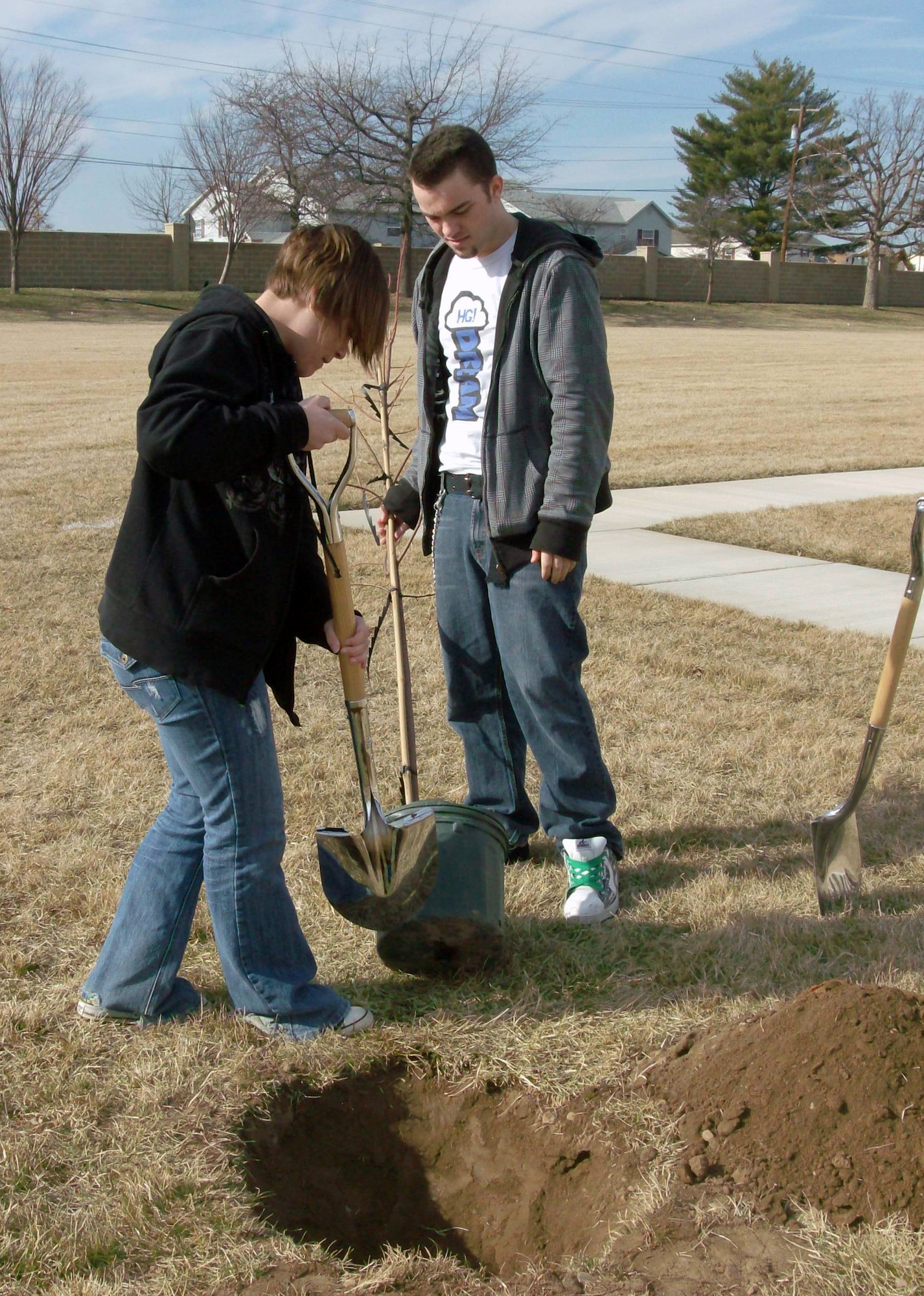 Ashley Brizendine and Michael Manchester, Jr., members of the Dover Air Force Base Youth Center, plant trees outside the Youth Center recently. Ms. Brizendine is the daughter of Master Sgt. Michael Grove, Jr., 436th Operations Support Squadron, and was recently named Team Dover’s Youth of the Year. Mr. Manchester, Jr., is the son of Master Sgt. Michael Manchester, 436th Airlift Wing Command Post, and often volunteers for Youth Center events. (Courtesy photo)