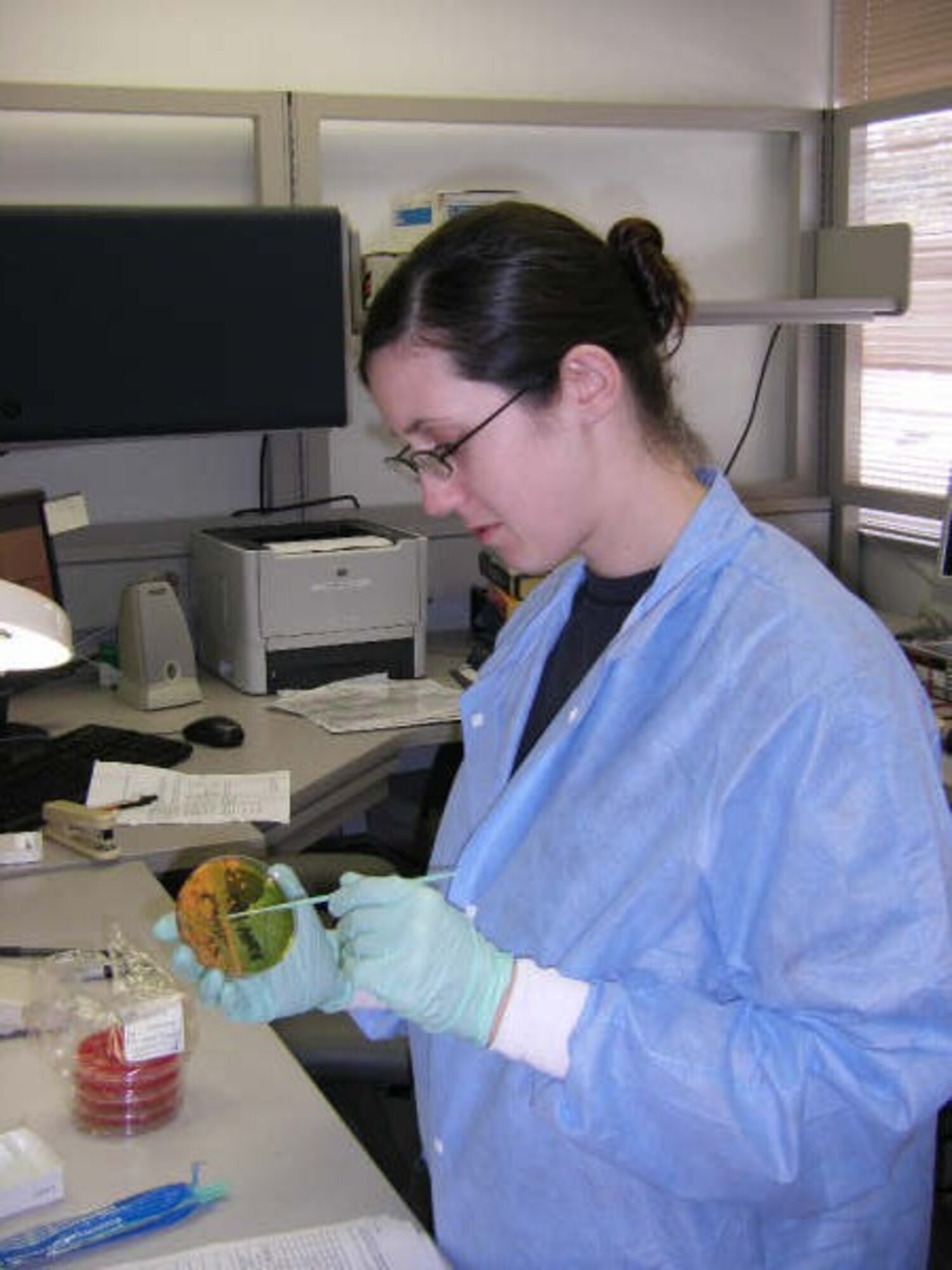 U.S. Air Force Senior Airman Pamela Torrez, a Labratory Techneician from the 18th Medical Support Squadron, performs a microbiology procedure to test the organism's sensitivity level to antibiotics. (Courtesy Photo) 
