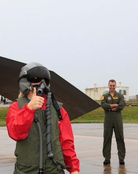 Kjerstan Lehman, a sixth grader at Ryukyu Middle School, tries on a pilots' G-suit and helmet during a class tour of the aircraft on Kadena Air Base. (Courtesy photo/Mr. Charles Steitz) 