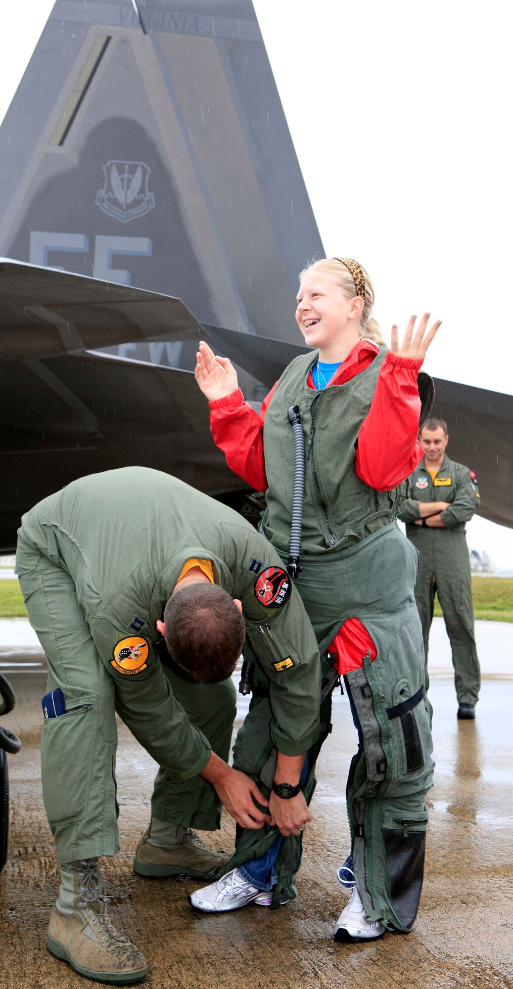 Kjerstan Lehman, a sixth grader at Ryukyu Middle School, tries on a pilots' G-suit during a class tour of the aircraft on Kadena Air Base. (Courtesy photo/Mr. Charles Steitz) 