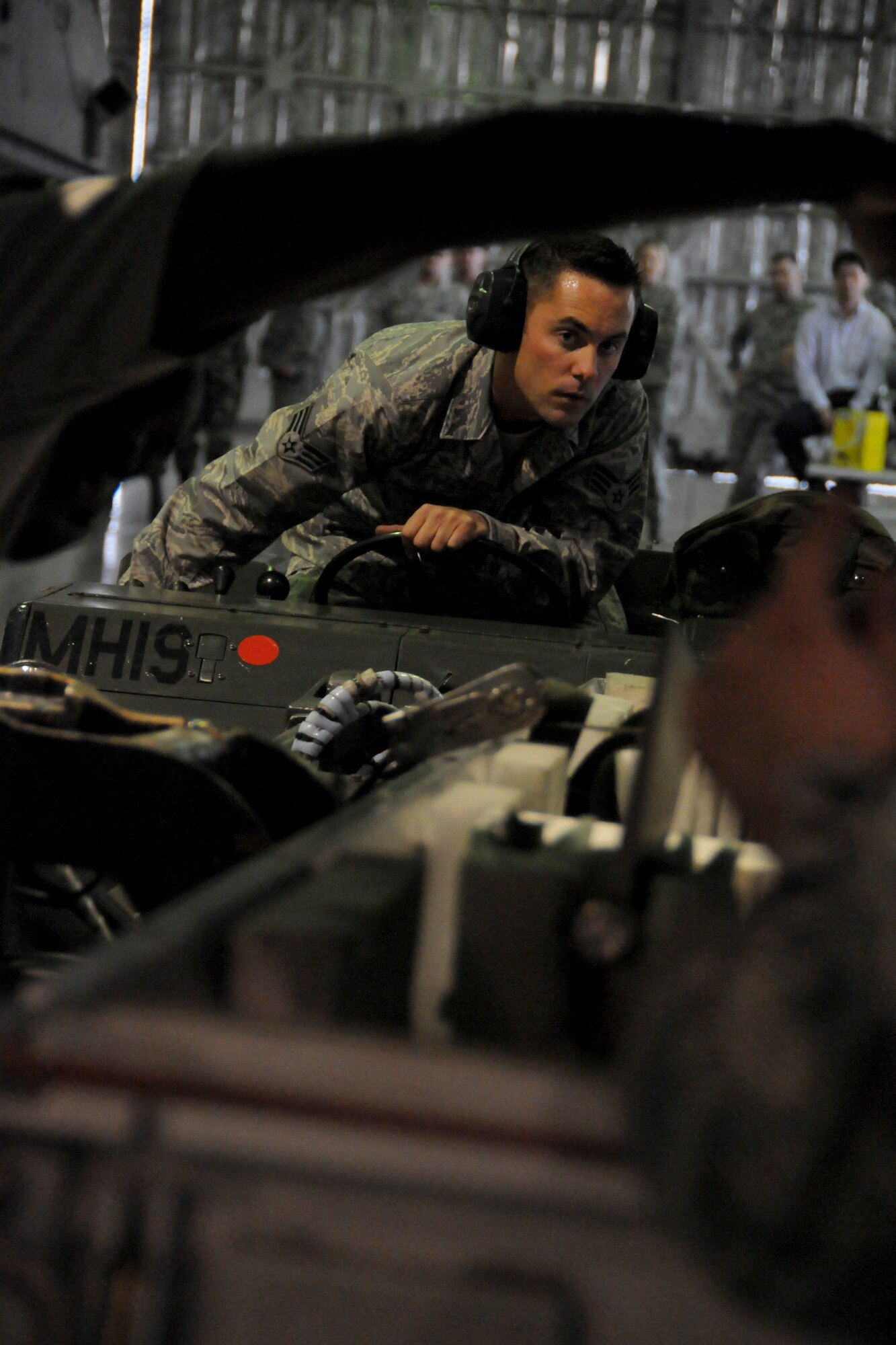 MISAWA AIR BASE, Japan -- Senior Airman Patrick Cannon, 35th Maintenance Squadron, along with his weapons-load crew members, race against the clock during a weapons-load competition April 10, 2009. The team’s time will be judged against a load crew downrange.  (U.S. Air Force photo by Senior Airman Jamal D. Sutter)