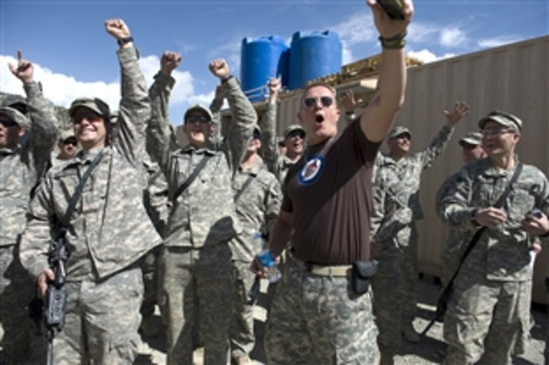Robert Patrick from TV's "The Unit" cheers on Max Martini in a race with soldiers assigned to Combat Outpost Deysie, Afghanistan, April 22, 2009. U.S. Navy Adm. Mike Mullen, chairman of the Joint Chiefs of Staff, is on a six-day tour of the U.S. Central Command area of responsibility to escort a USO tour, meet with counterparts and visit troops. 
