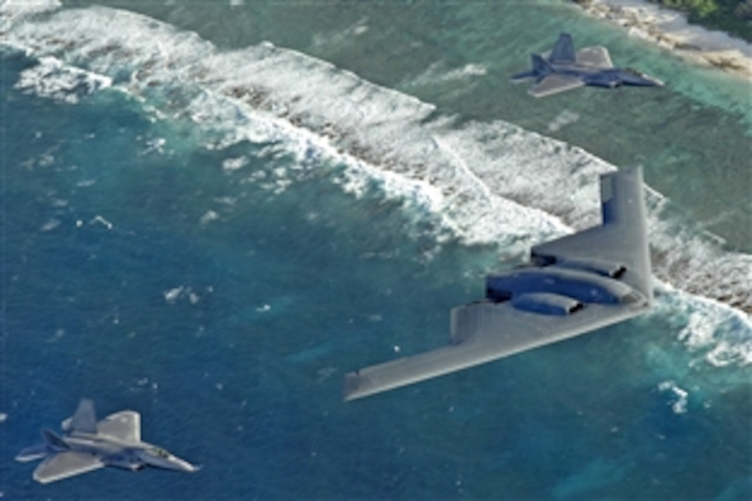 Two F-22 Raptors and a B-2 Spirit bomber deployed to Andersen Air Force Base, Guam, fly in formation over the Pacific Ocean, April 21, 2009. The occasion marks the first time F-22s and B-2s, the key national strategic stealth assets in the Air Force inventory, deployed together outside the continental United States.