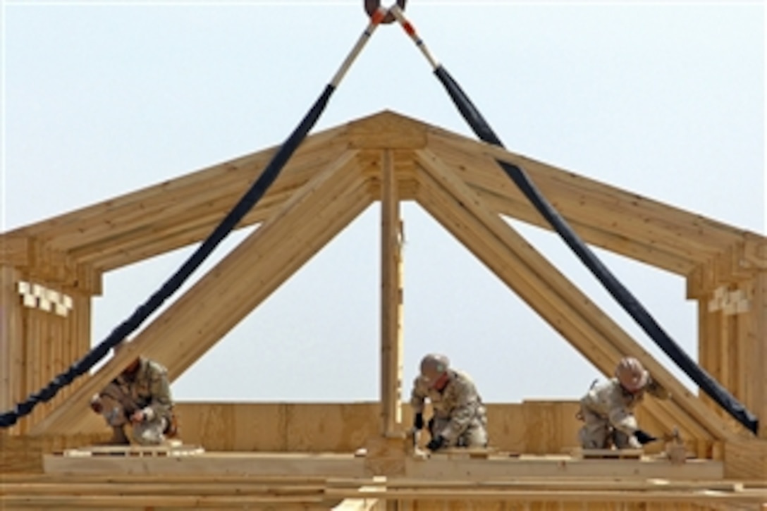 U.S. Navy Seabees secure trusses on a Southwest Asia hut during a project on forward operating base Leatherneck, Helmand province, Afghanistan, April 17, 2009. The Seabees are assigned to Naval Mobile Construction Battalion 5, and is deployed to Afghanistan supporting the NATO International Security Assistance Force. NMCB-5 is one of the Naval Expeditionary Combat Command warfighting support elements providing host nation construction support and security.
