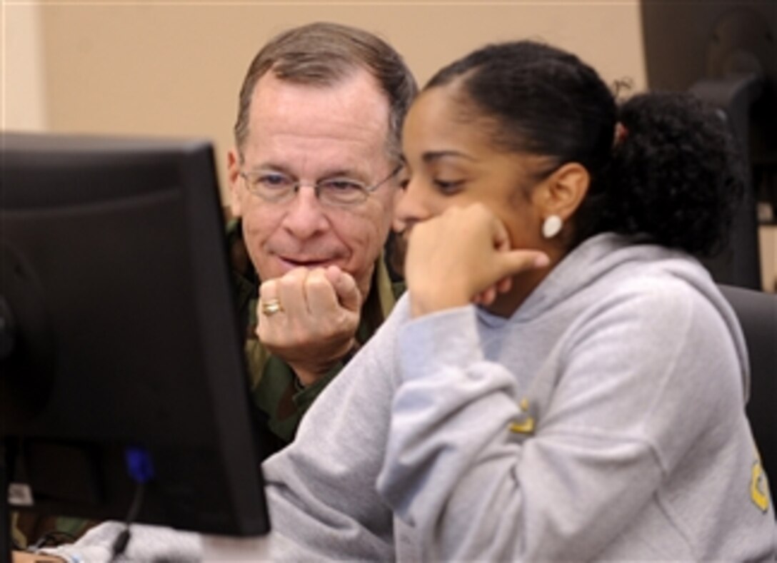 Chairman of the Joint Chiefs of Staff Adm. Mike Mullen (left), U.S. Navy, talks with Nain Gomez about online college courses during his visit to the Warrior and Family Support Center at Fort Sam Houston in San Antonio, Texas, on April 17, 2009.  Gomez is doing schoolwork while visiting her brother who is recovering at the Brooke Army Medical Center at Fort Sam Houston after being wounded by an improvised explosive device.  