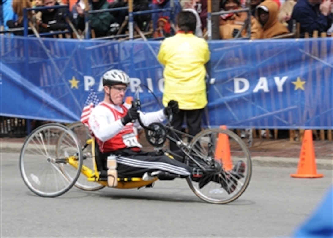 Maj. Kent Solheim rides his hand bike down the chute of the 113th